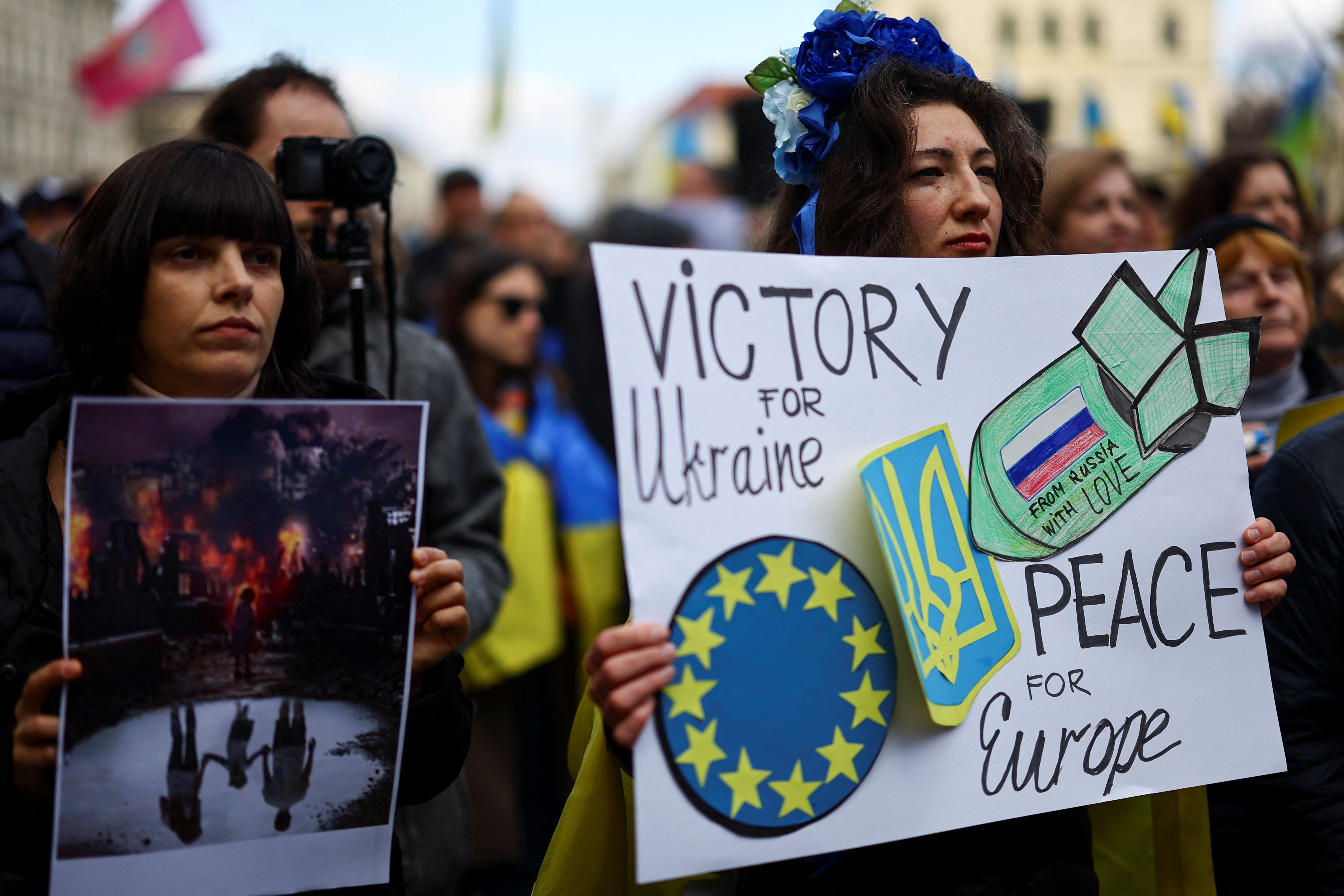 A demonstrator holds a placard opposing Russia’s nuclear threat during a Munich protest