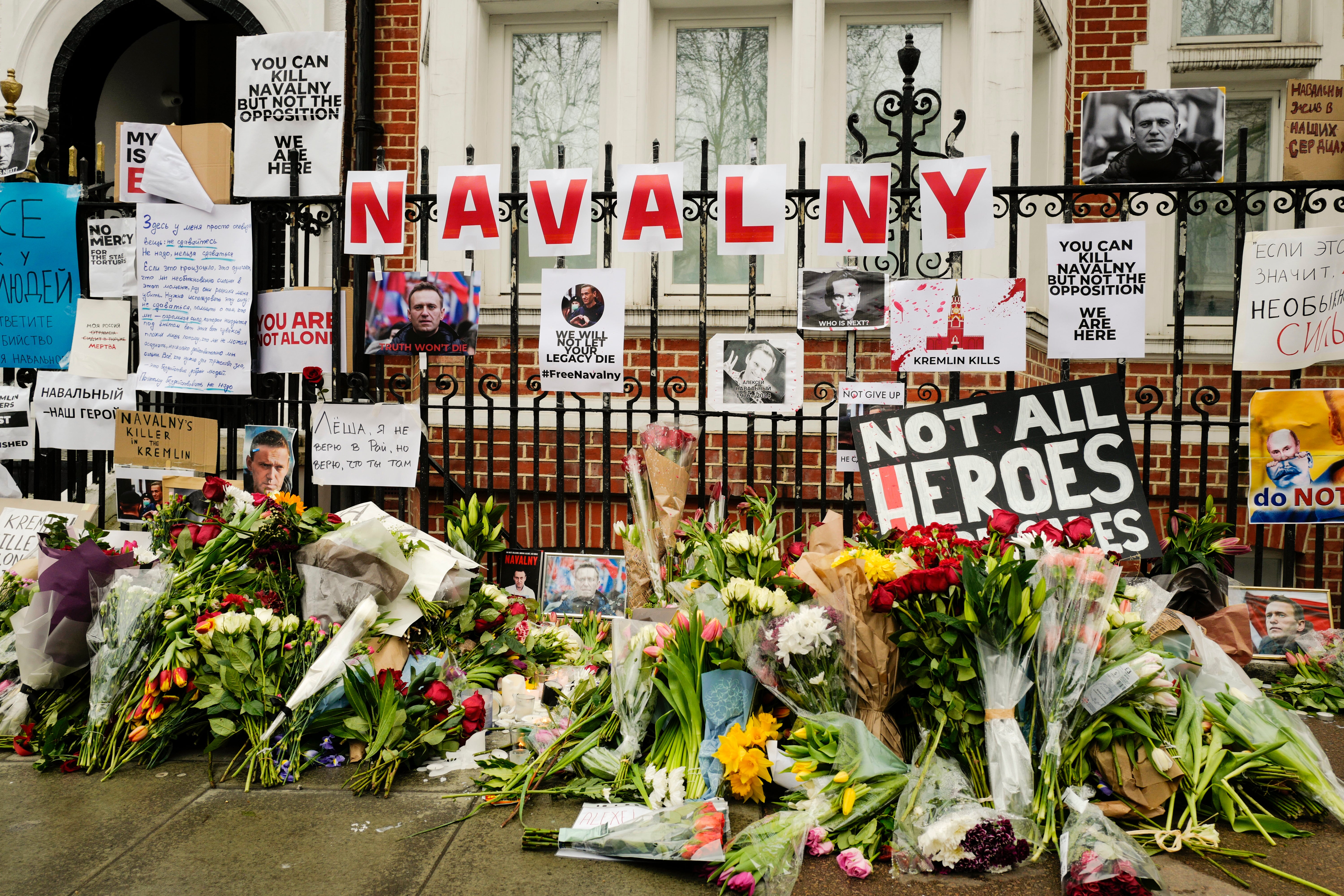 Flowers and tributes are left opposite the Russian embassy, to commemorate the death of Alexei Navalny in London