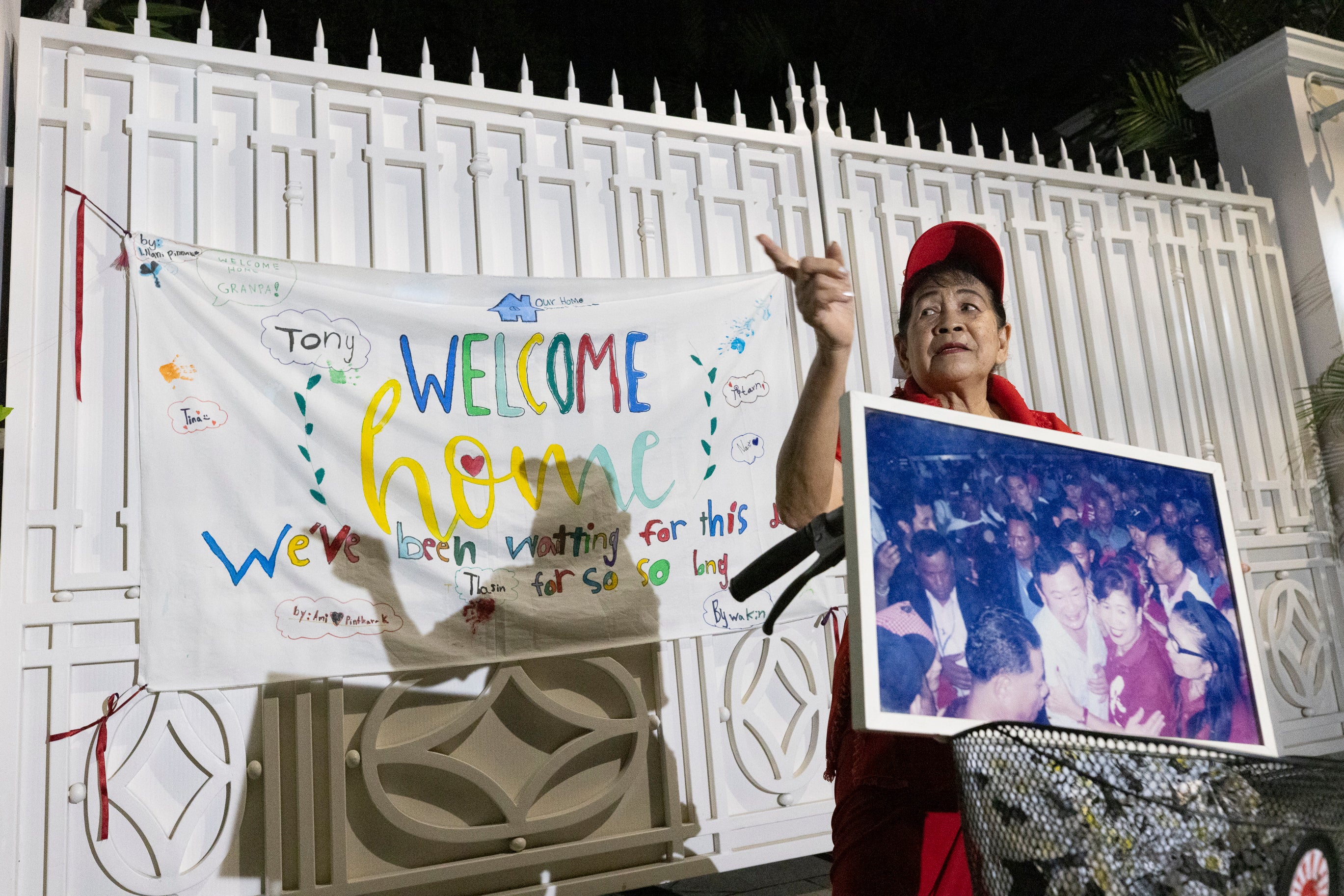 A supporter waits in front of former Thai prime minister Thaksin Shinawatra’s residence