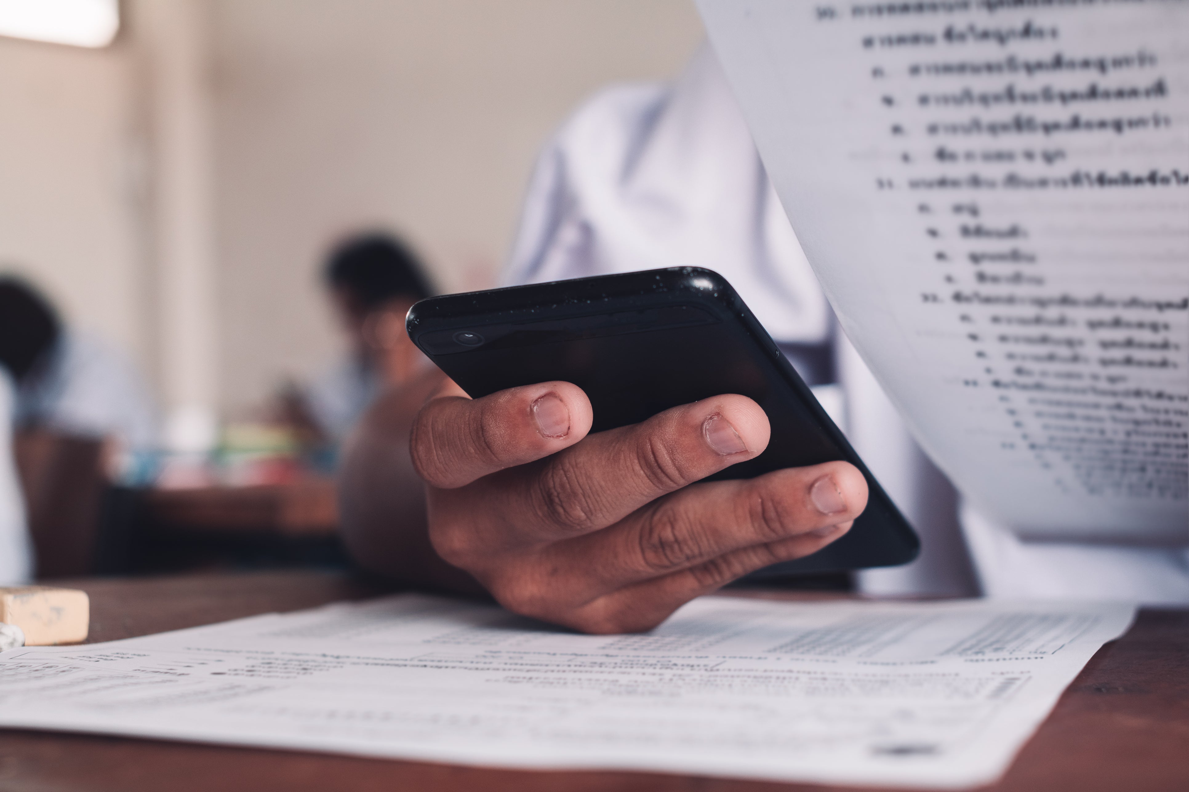 A student using their mobile phone during an exam