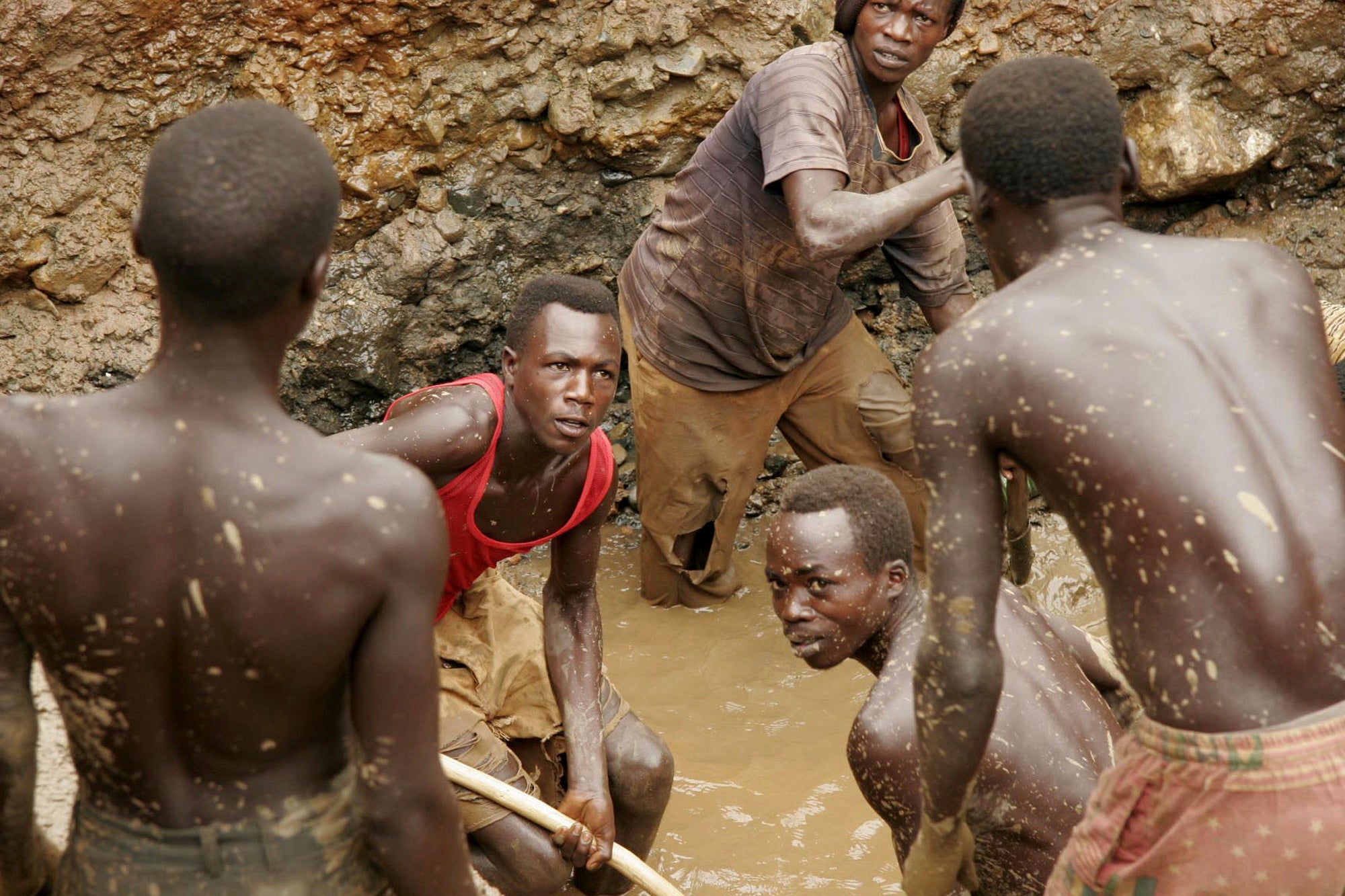 Former militia fighters work in a makeshift mine digging for gold in the town of Ika Barrier, Democratic Republic of Congo