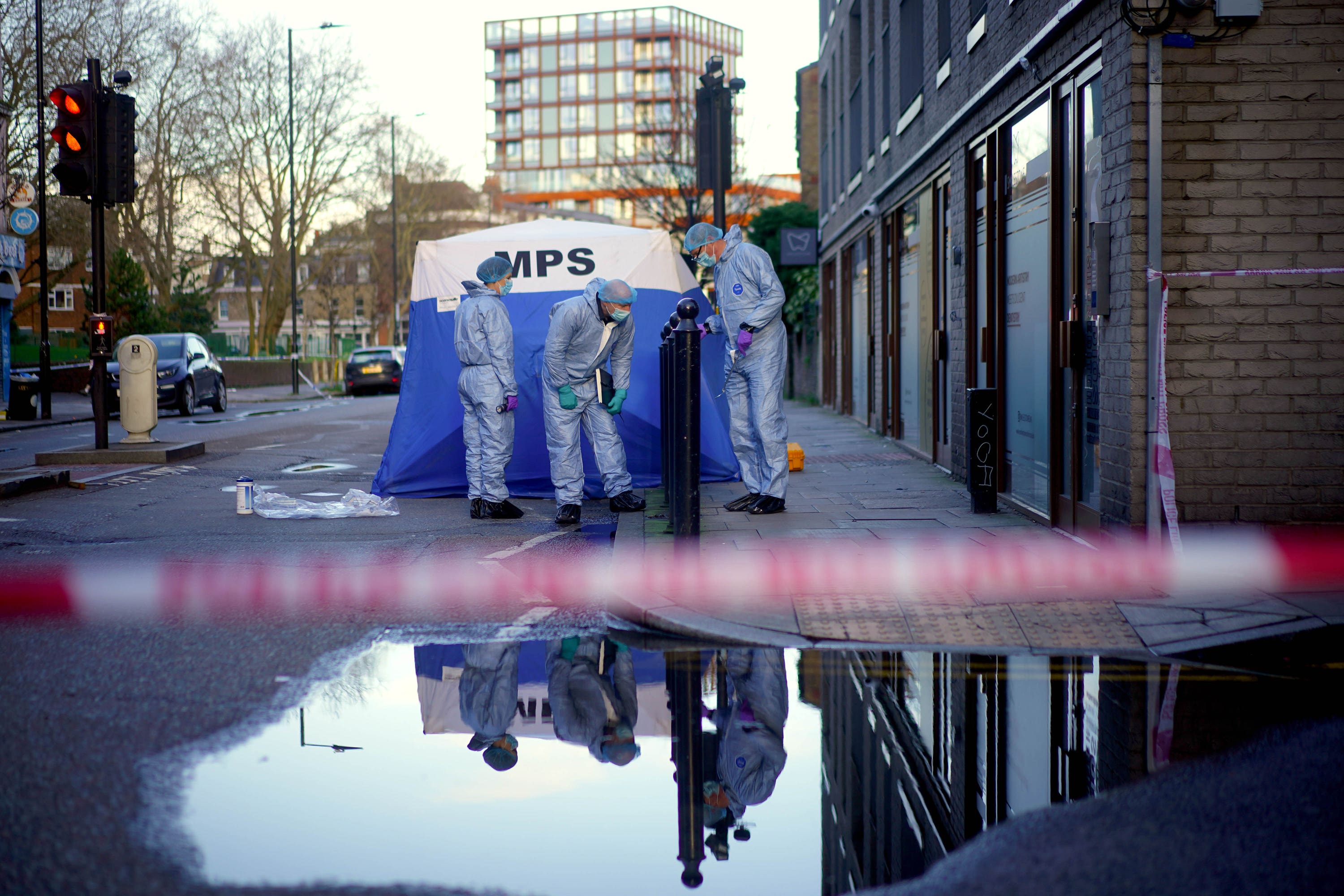 Forensic officers work near the scene where a 17-year-old died after being stabbed in Hackney Road in Shoreditch on Saturday (Victoria Jones/PA)