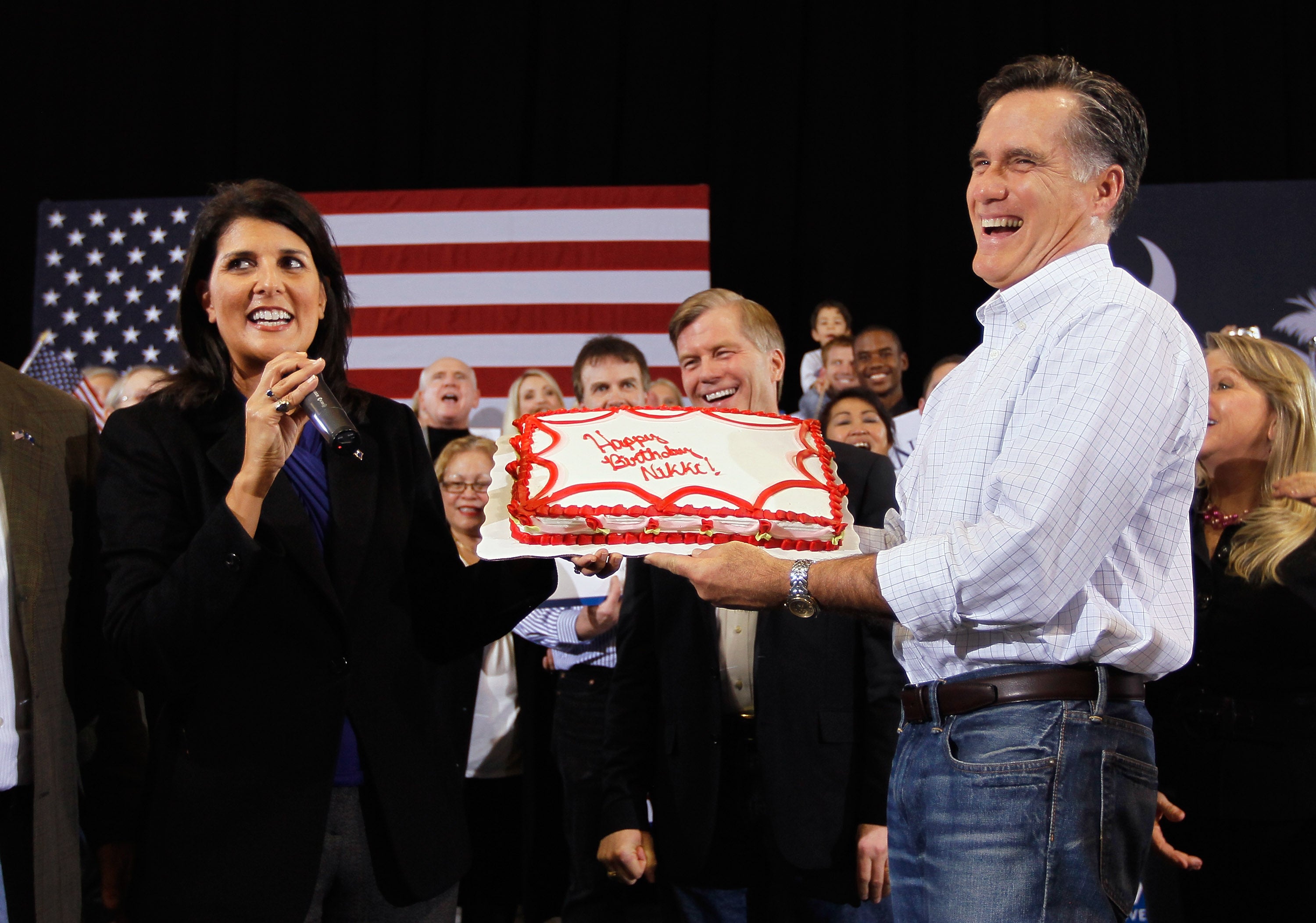 Republican presidential candidate, former Massachusetts Gov. Mitt Romney gives a birthday cake to South Carolina Gov. Nikki Haley during a campaign rally at Charleston Area Convention Center on January 20, 2012 in North Charleston, South Carolina