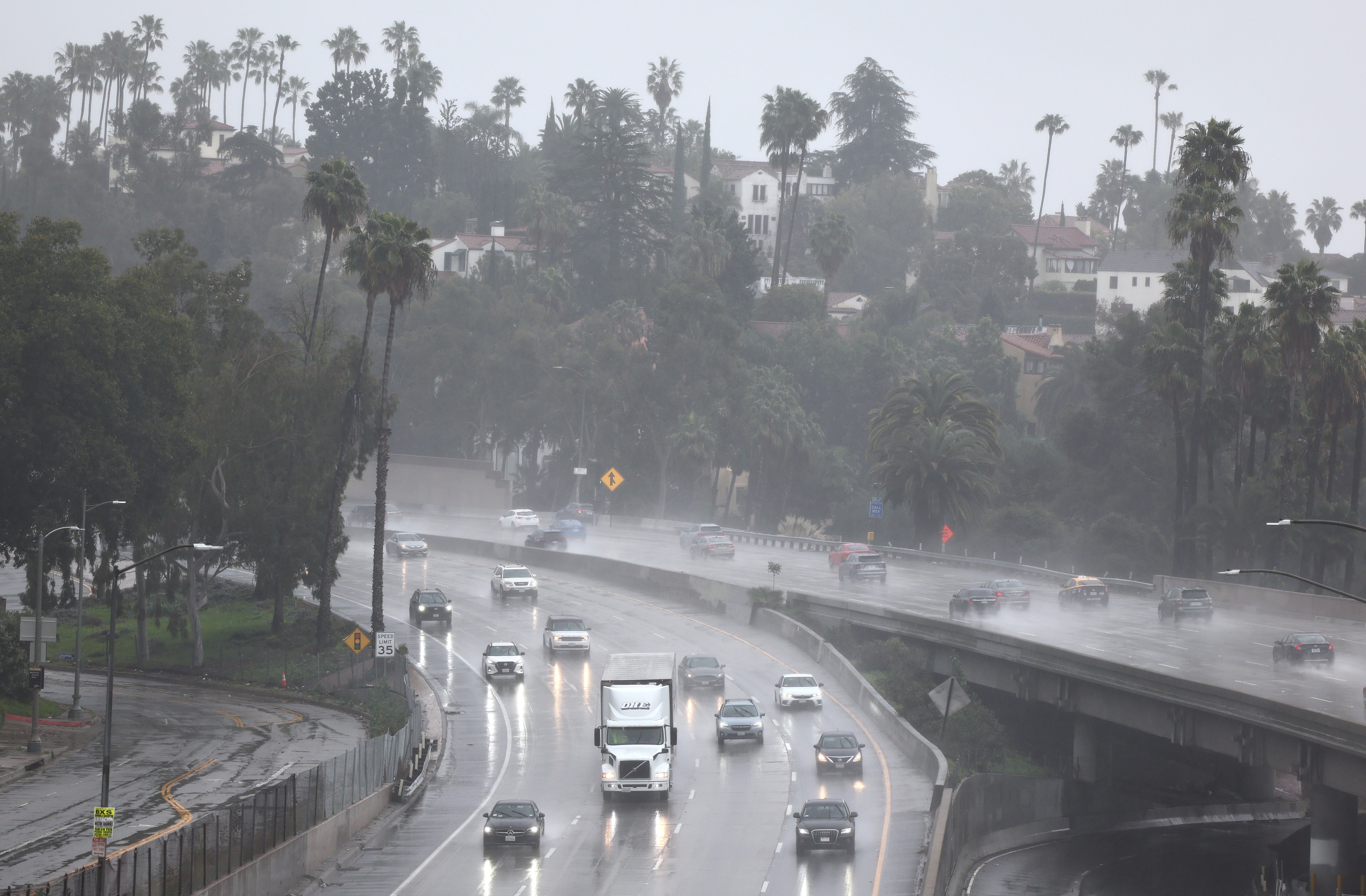 Cars drive through torrential rain on US-101 in Los Angeles on 19 February 2024