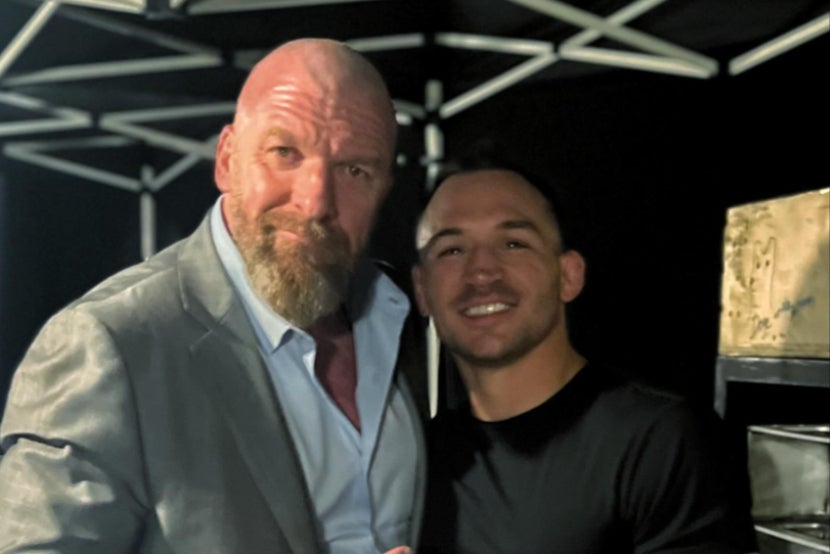 Chandler (right) with WWE executive and former wrestler Triple H