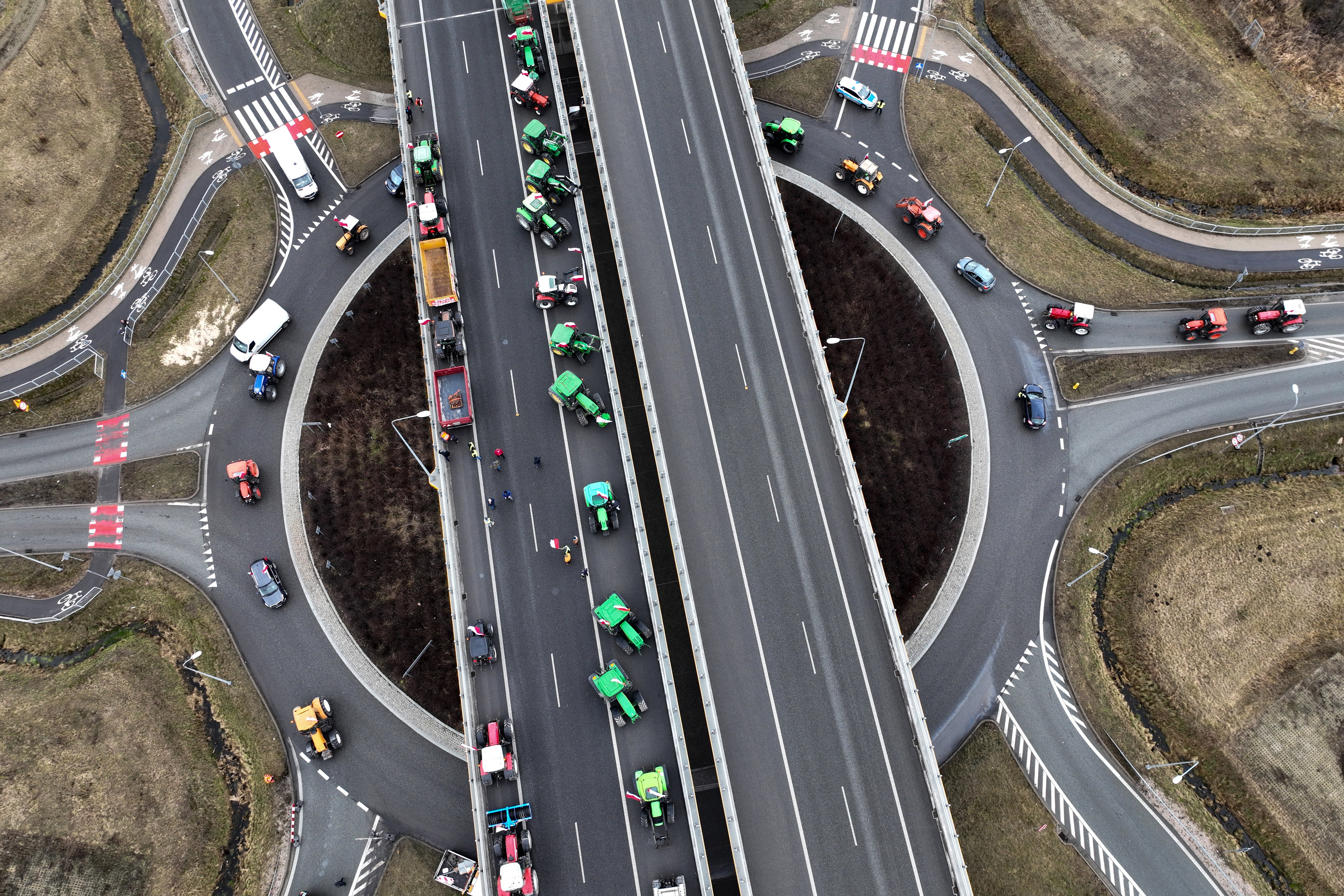 This aerial view taken on February 20, 2024 shows Polish farmers with their tractors and vehicles blocking a highway