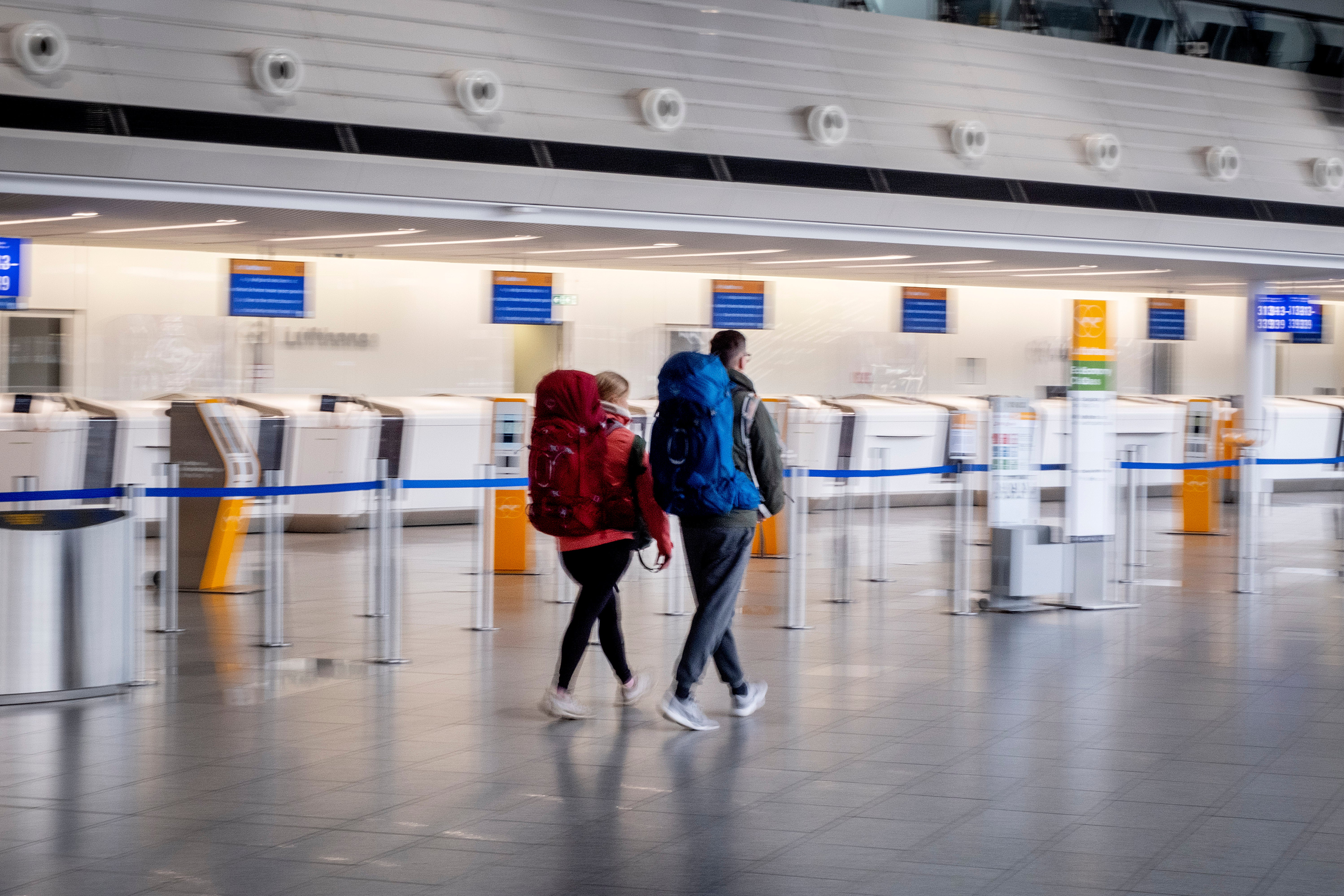 Passengers walk through a terminal at the airport in Frankfurt, Germany on Tuesday