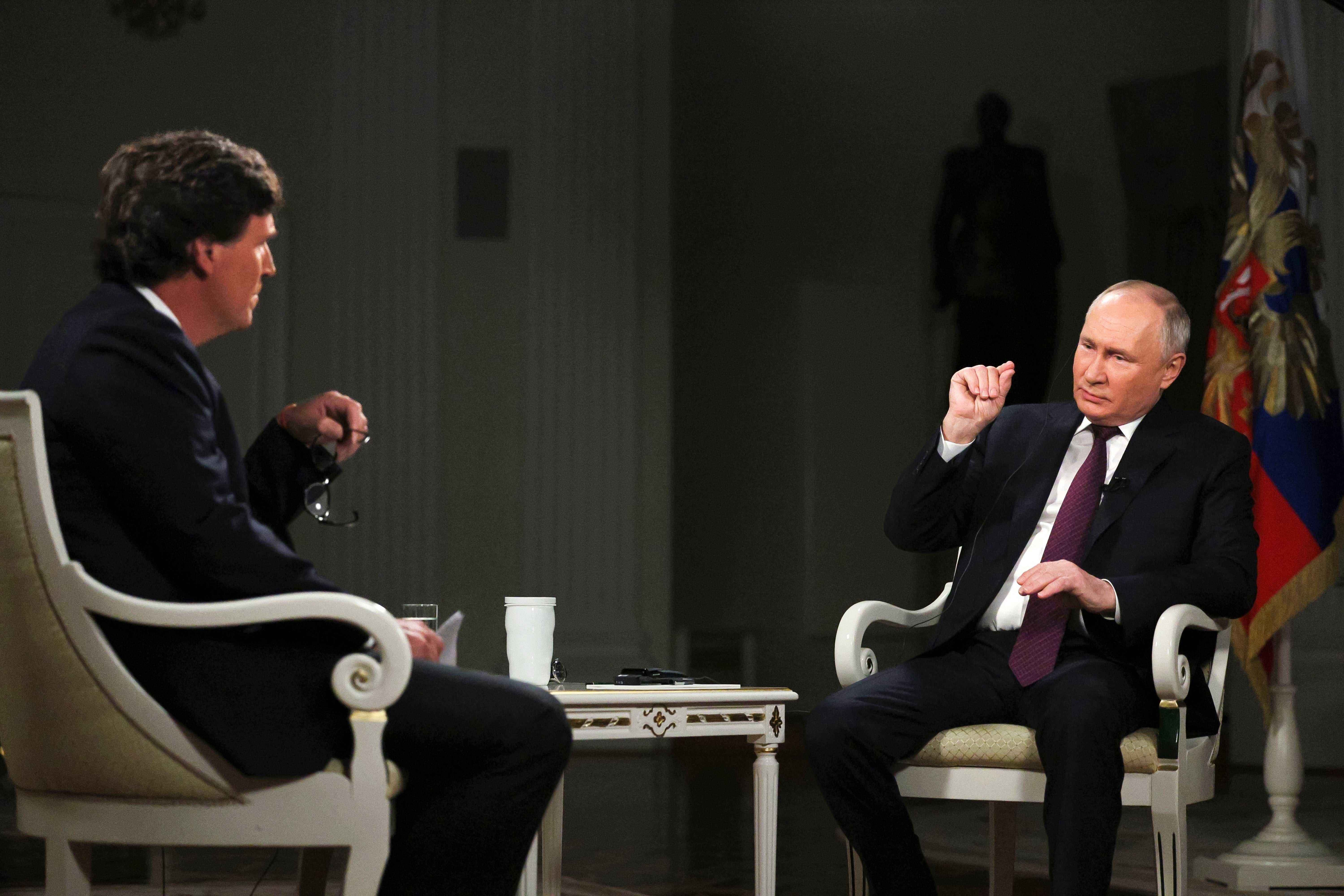 Russian President Vladimir Putin, right, speaks during an interview with former Fox News host Tucker Carlson