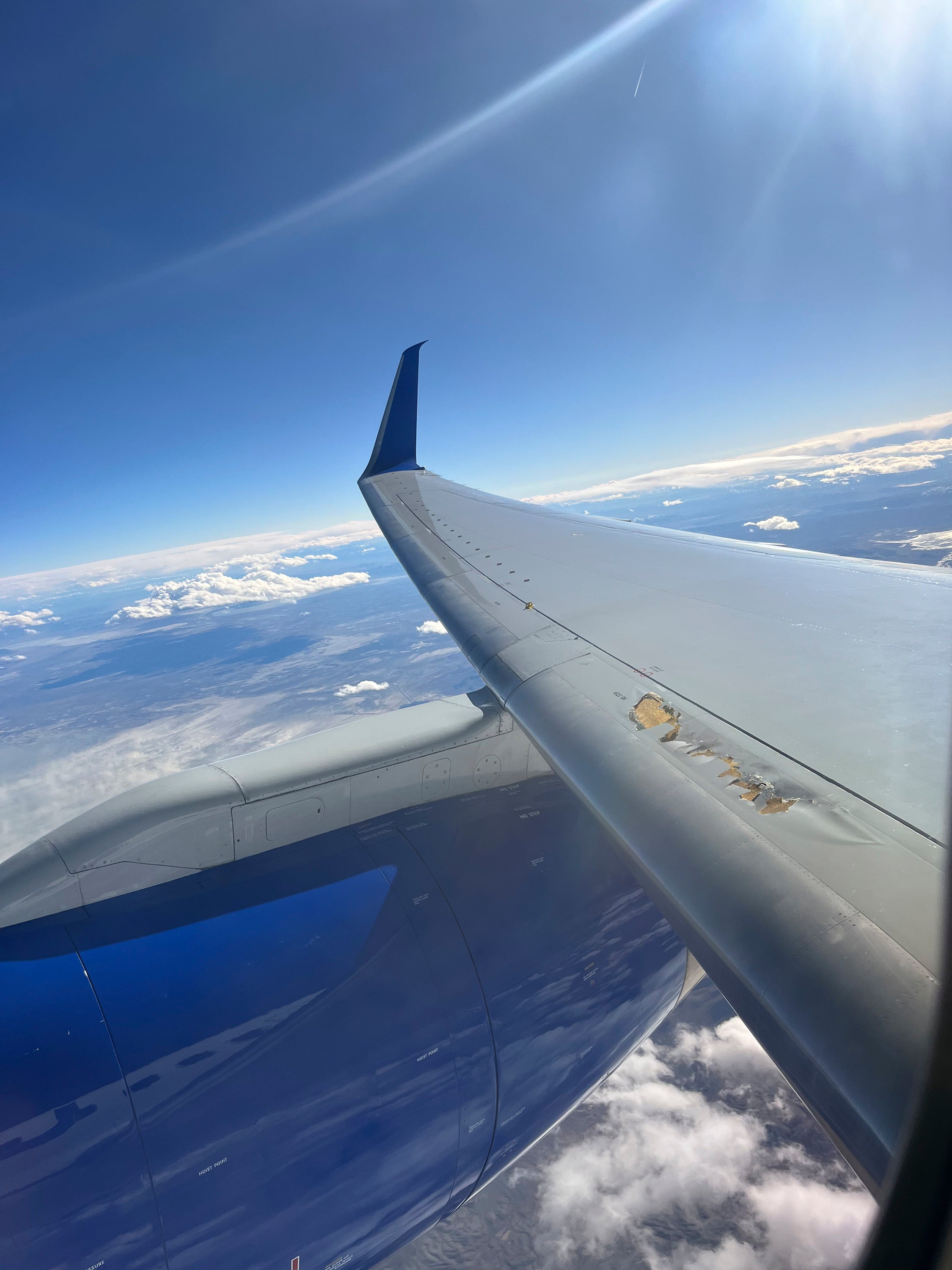 Photo provided by Kevin Clarke shows a United Airlines plane with damage to one of its wings