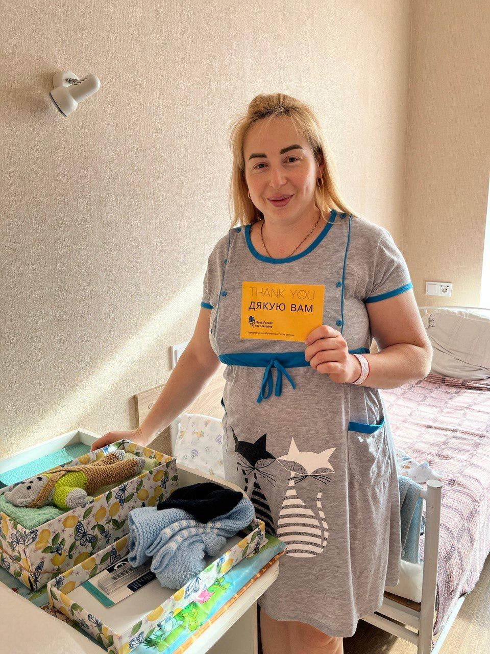 A new mother receiving crafted items in Ukraine.