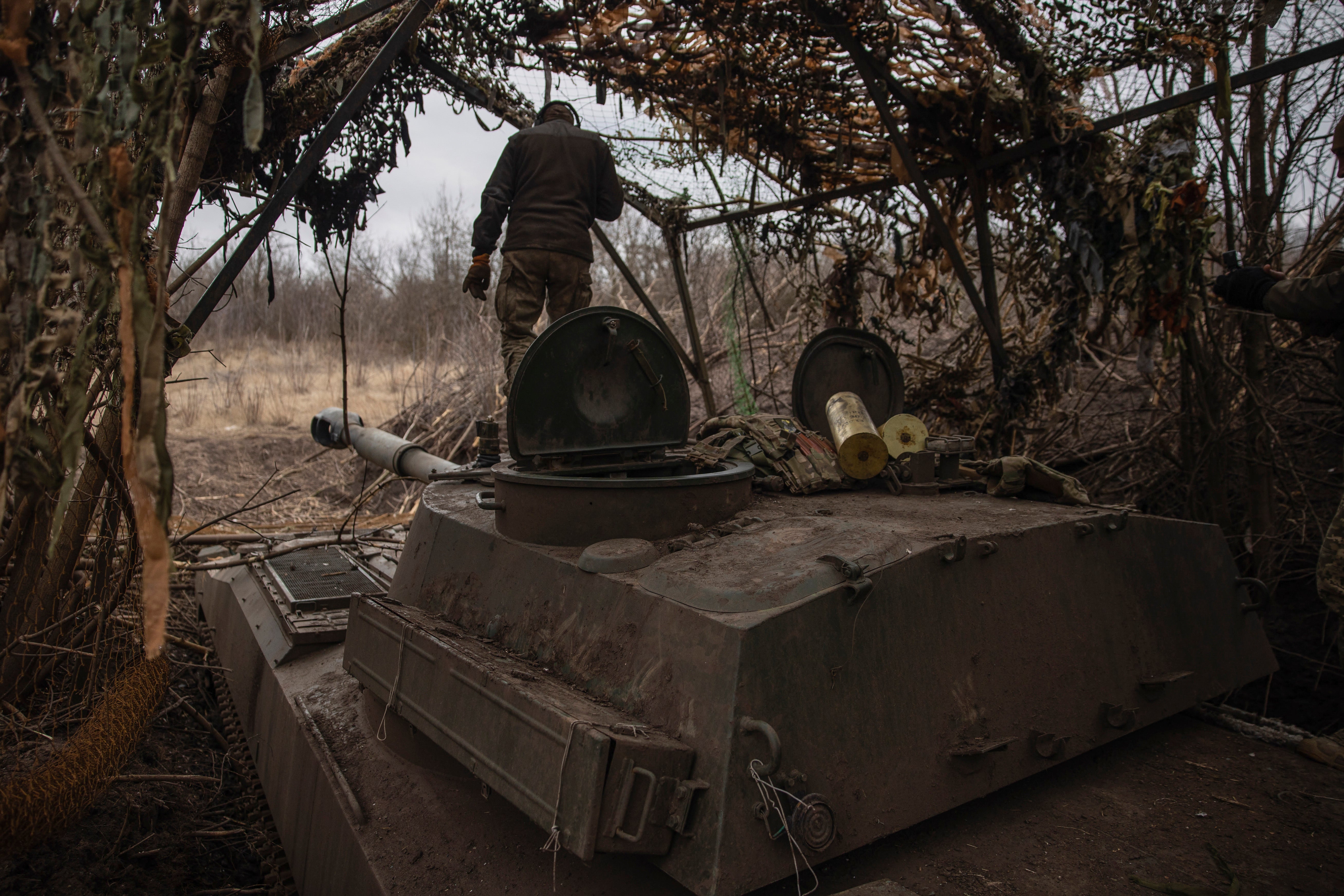 Ukrainian soldiers prepare a self-propelled artillery vehicle to fire towards Russian positions on the front line in the Donetsk region