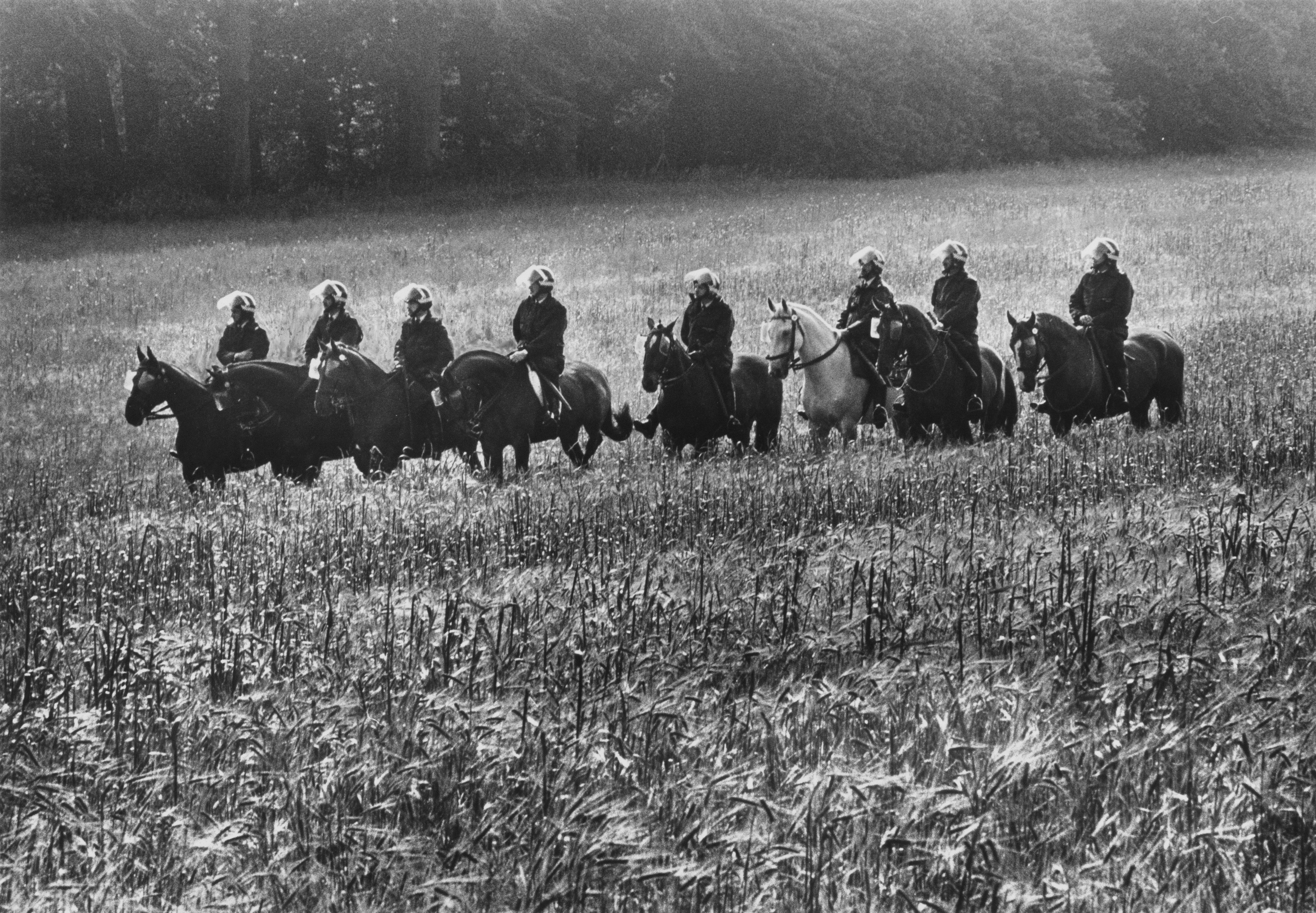 Riot police await orders in fields surrounding the Orgreave Coking Works, scene of an infamous battle with miners, in Yorkshire in 1984