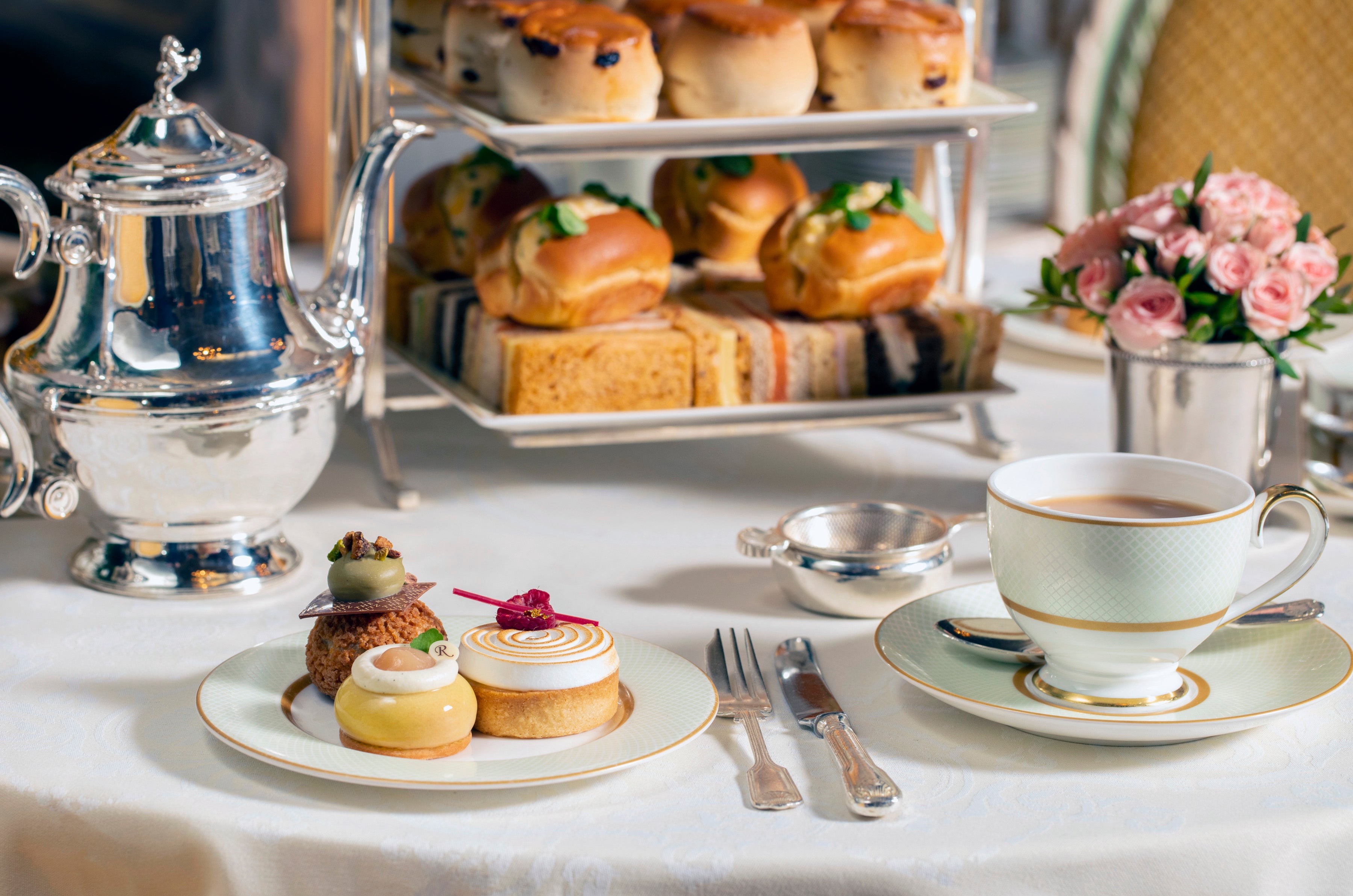 Tiers of scones, sandwiches and sponge cake await