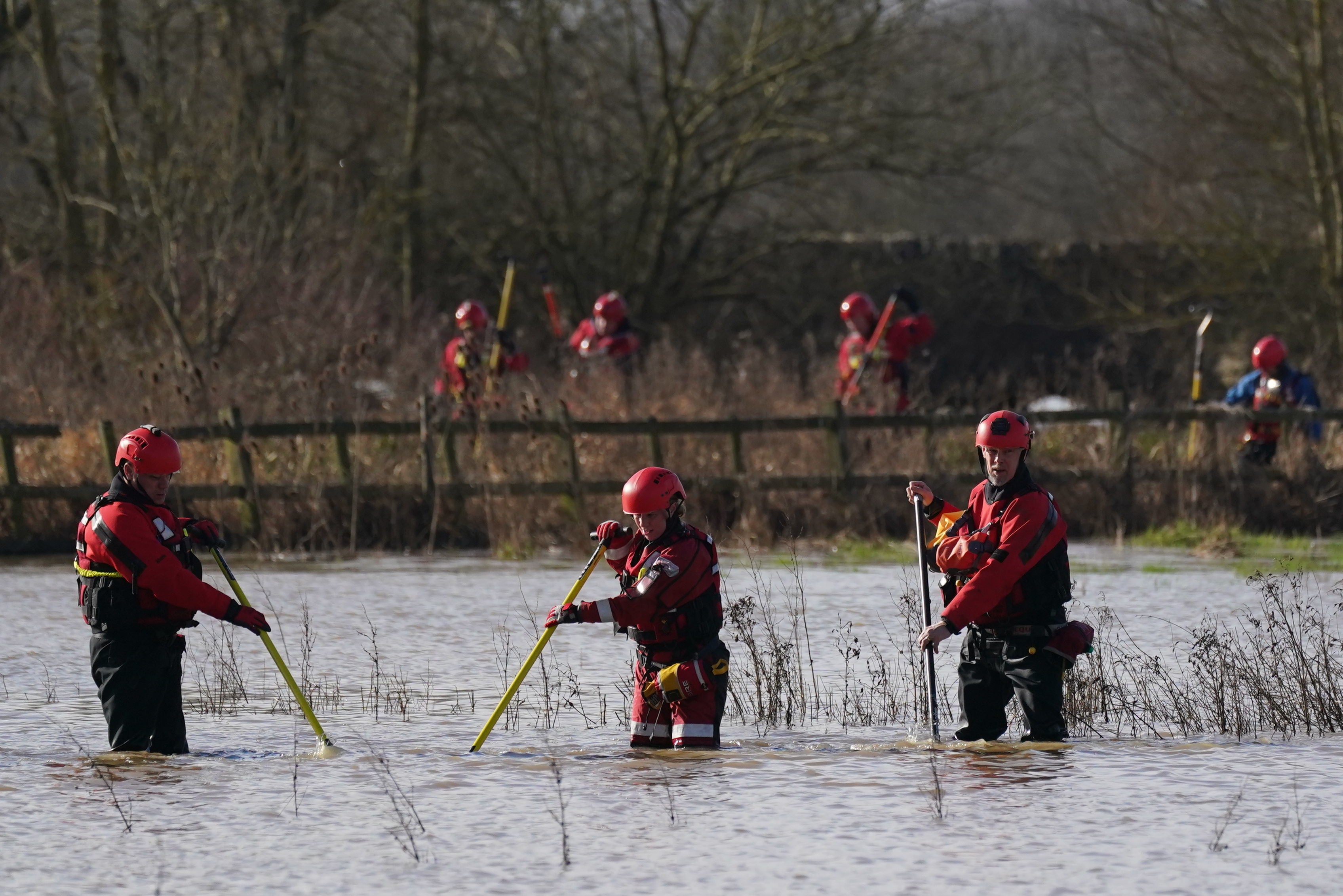 Rescue workers search marshland by the River Soar