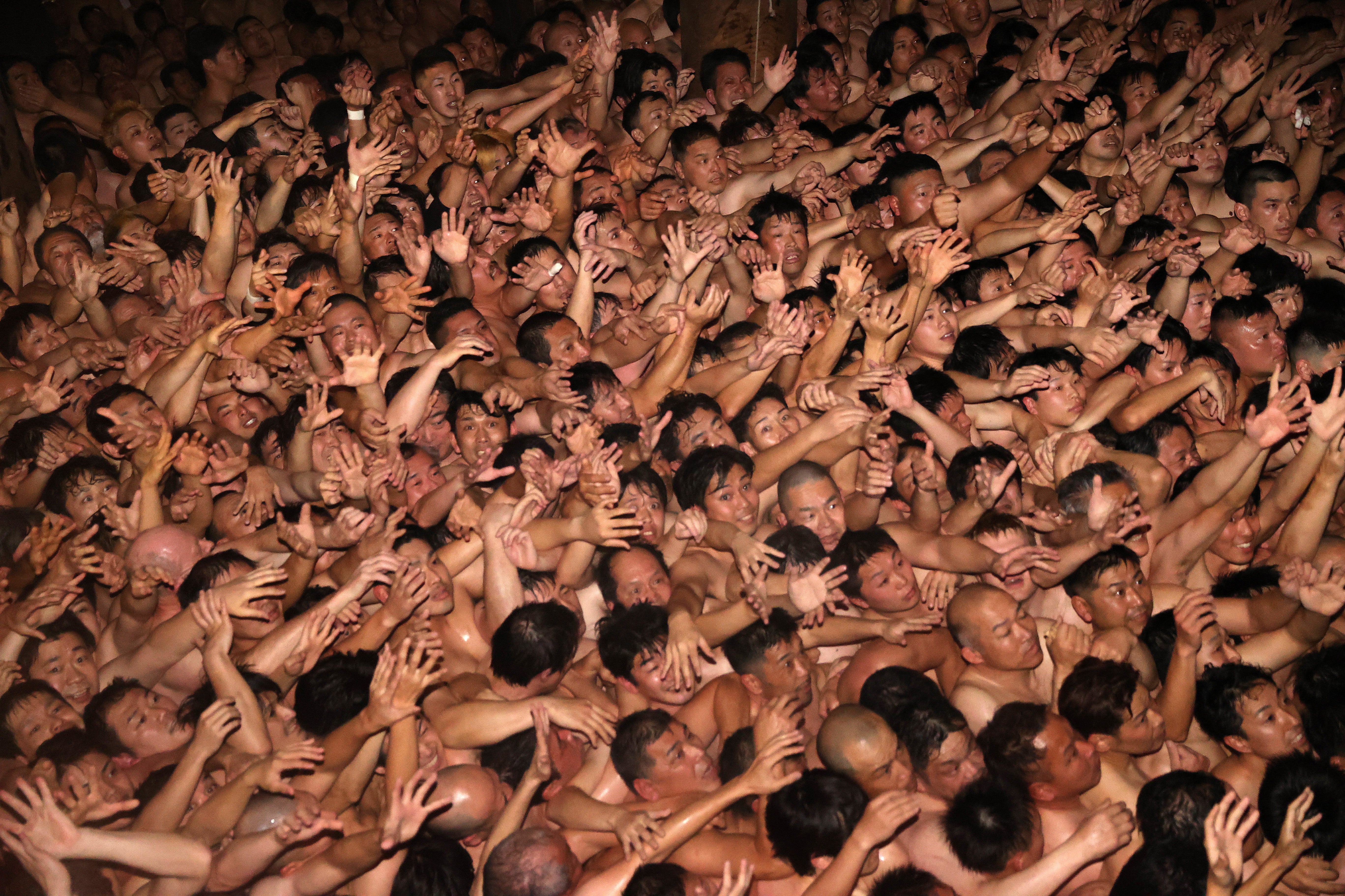 Approximately 9,000 men in loincloths try to snatch a lucky wooden stick during the ‘Eyo’ naked festival at Saidaiji Temple