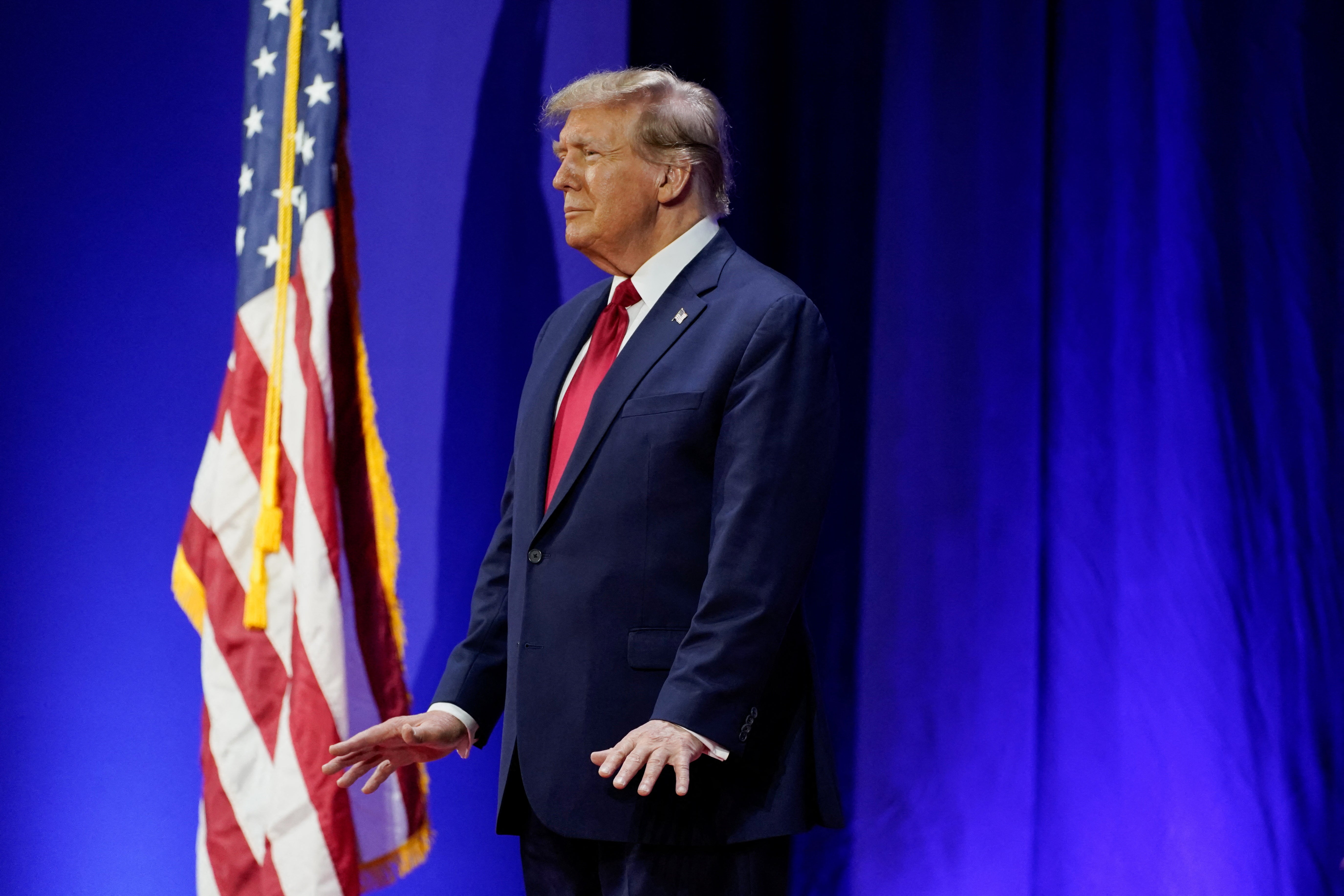 Trump stood still after entering the hall before eventually beginning to sway gently to the music