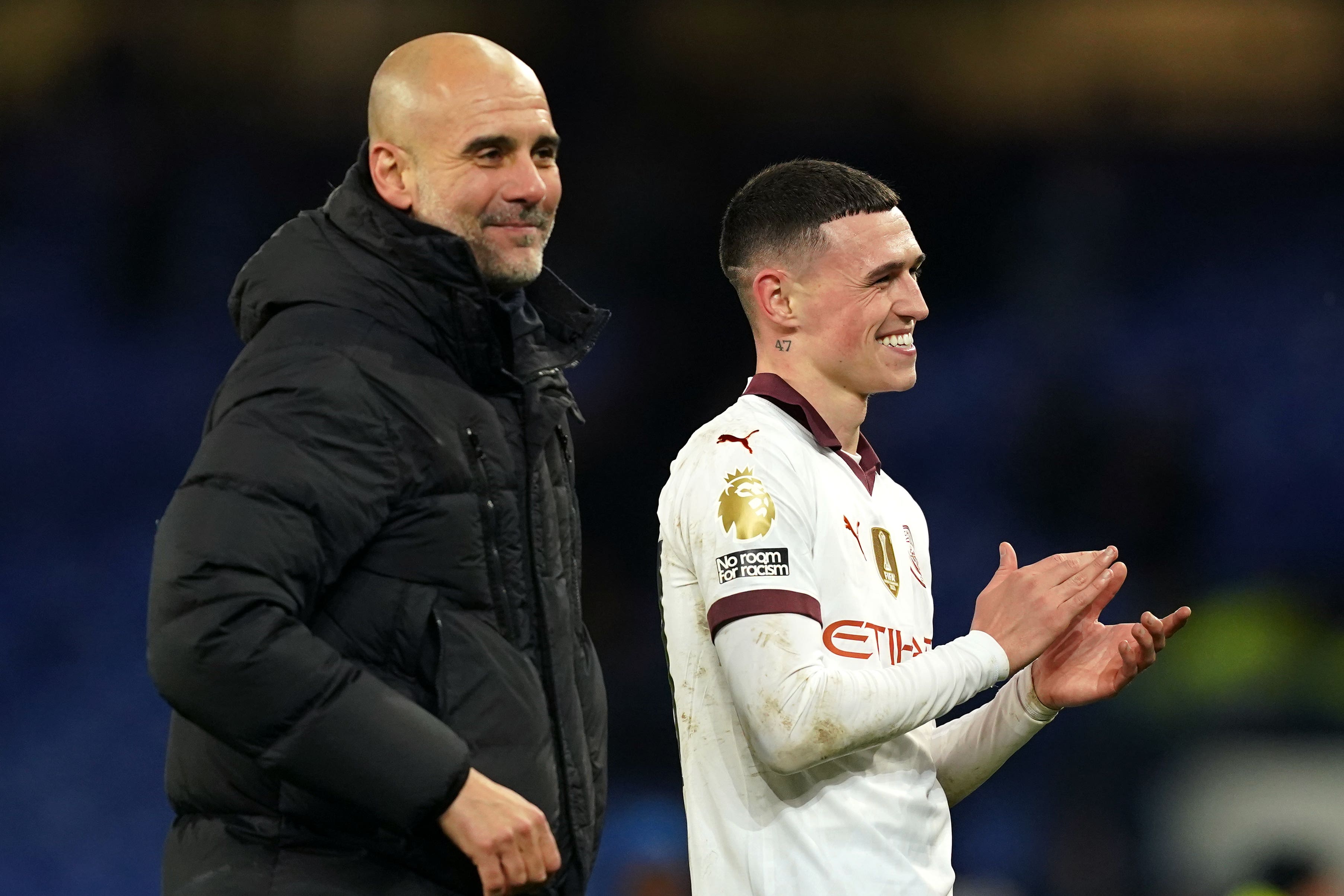 Manchester City manager Pep Guardiola with in-form Phil Foden (Martin Rickett/PA)