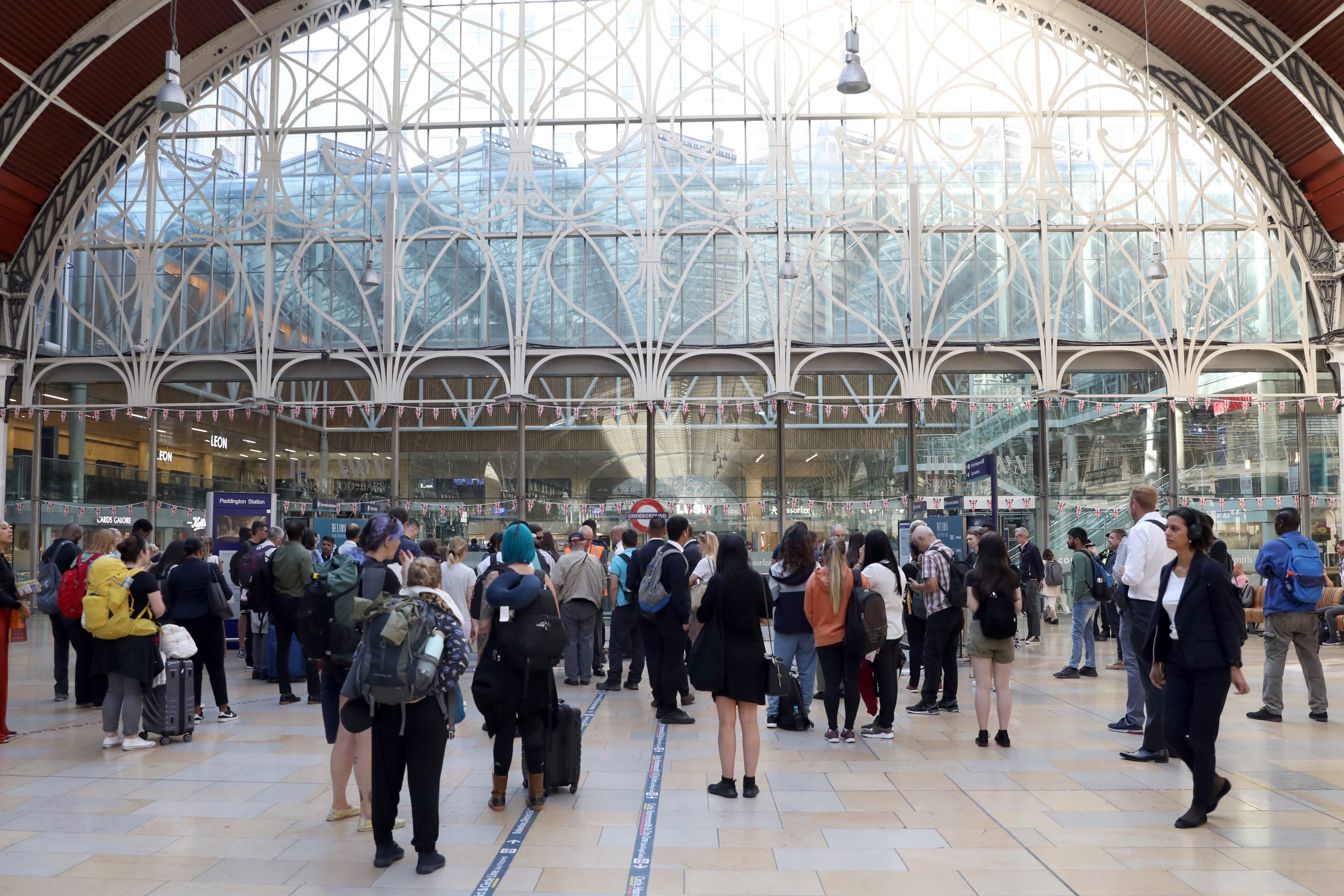 Passengers wait at Paddington station in London (Ashlee Ruggels/PA)