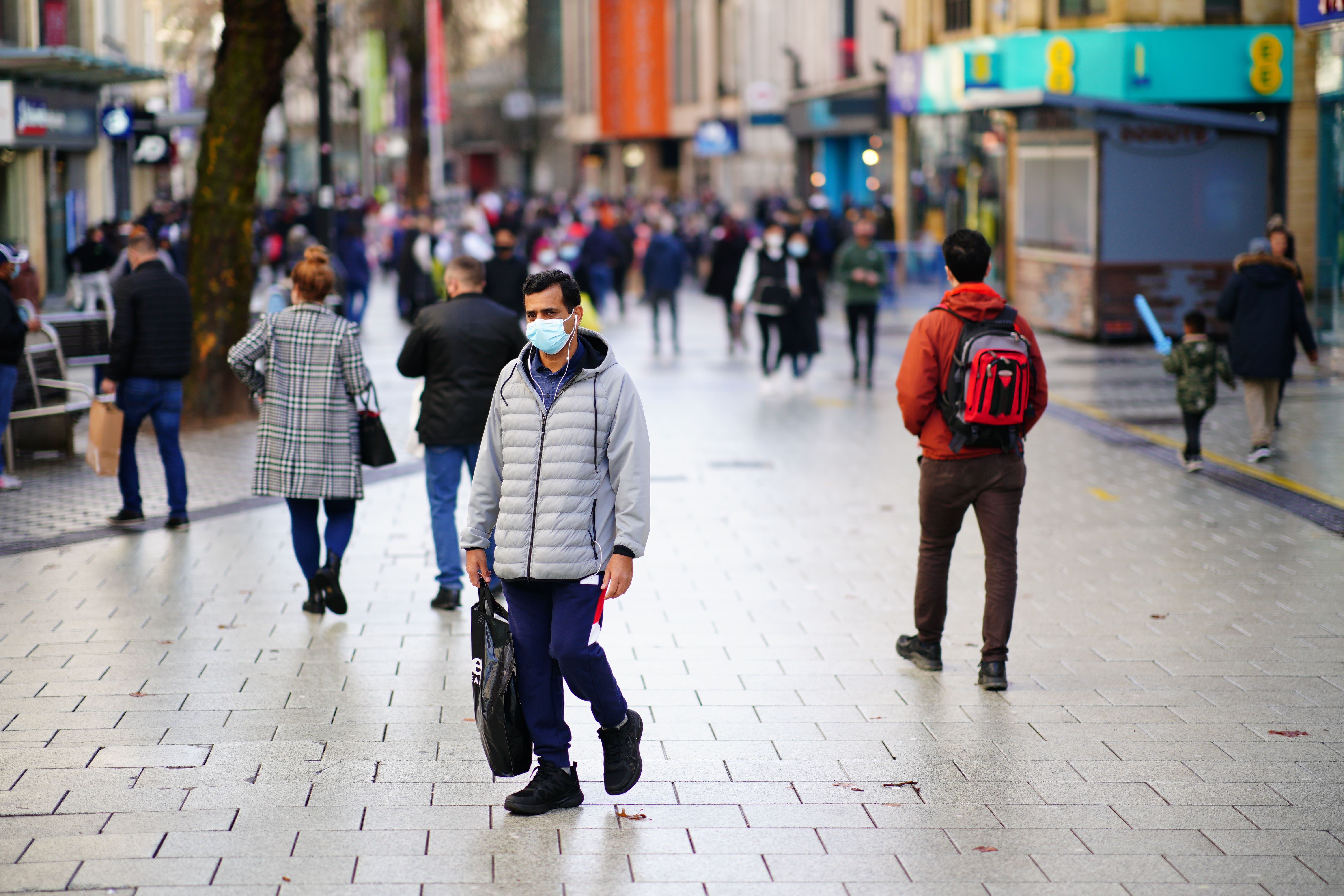 Shoppers walk through the centre of Cardiff, Wales as new Covid-19 rules came into force in 2021 (Ben Birchall/PA)