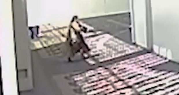 The female shooter is seen holding up an AR-style rifle