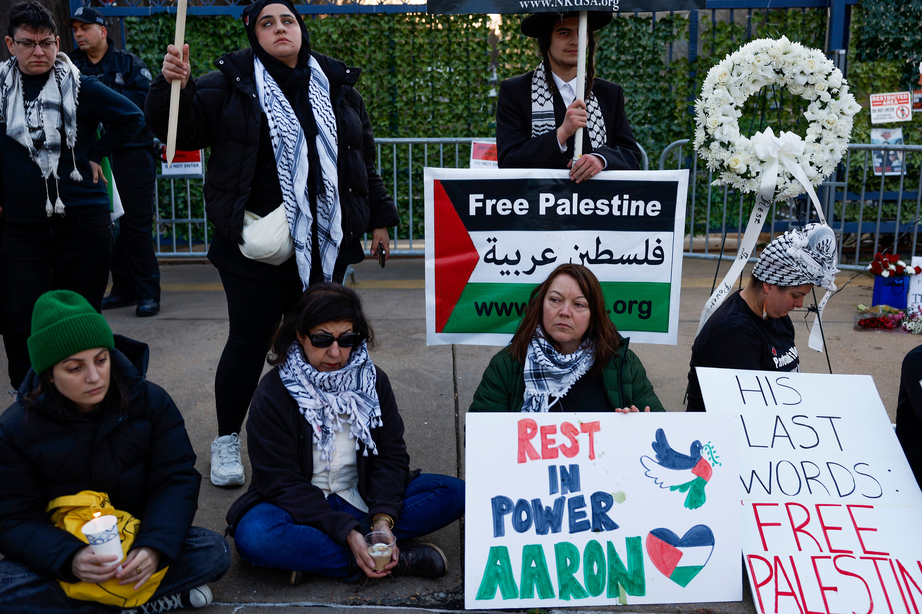 People participate in a vigil for U.S. Air Force active-duty airman Aaron Bushnell outside the Israeli Embassy on February 26, 2024 in Washington, DC. Bushnell died after setting himself on fire while live streaming, according to published reports, in front of the Israeli Embassy in protest over the Gaza war.