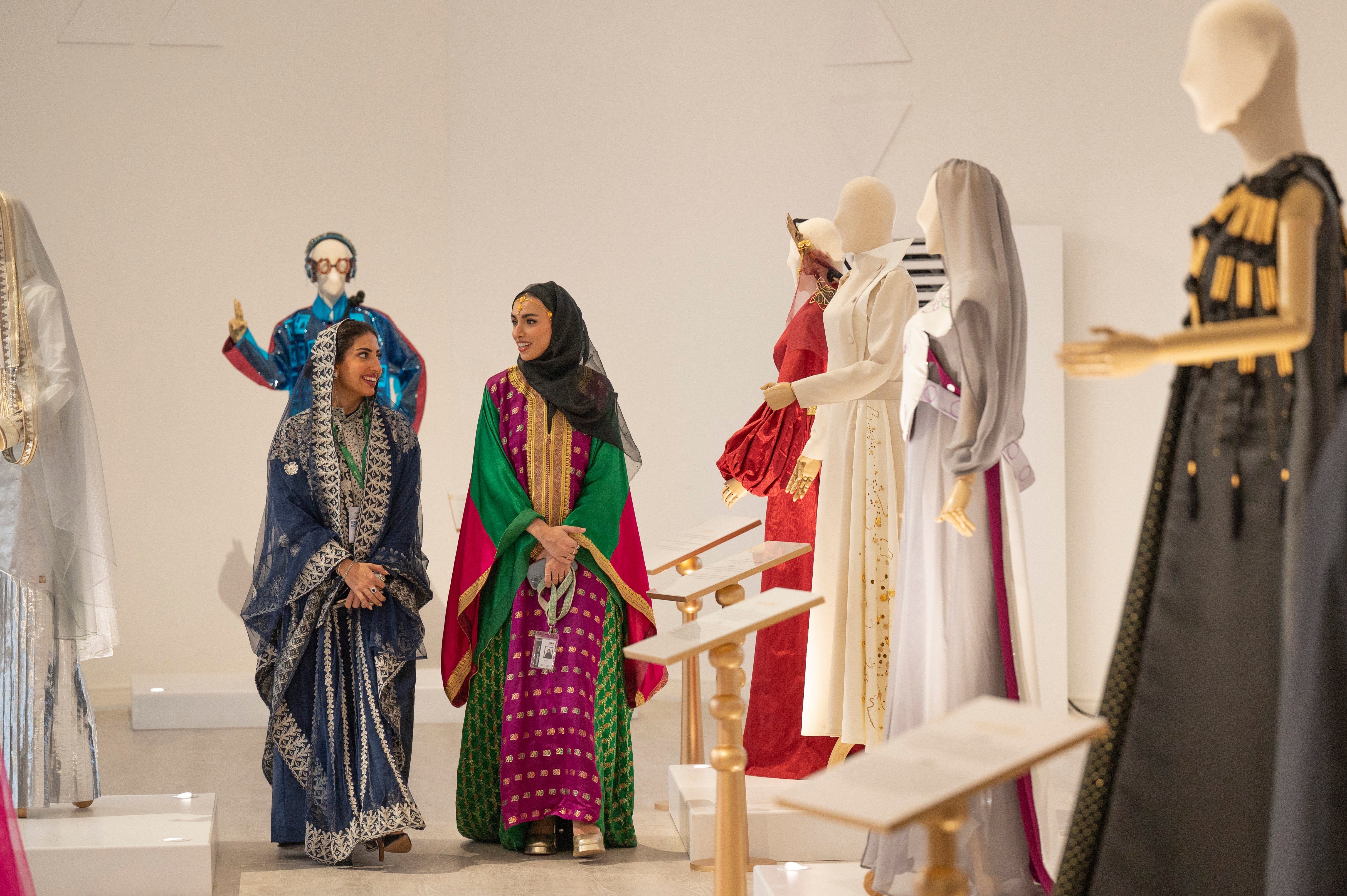 Elegant Saudi women in their colourful traditional thobes, stroll through the Saudi 100 Brands Exhibition