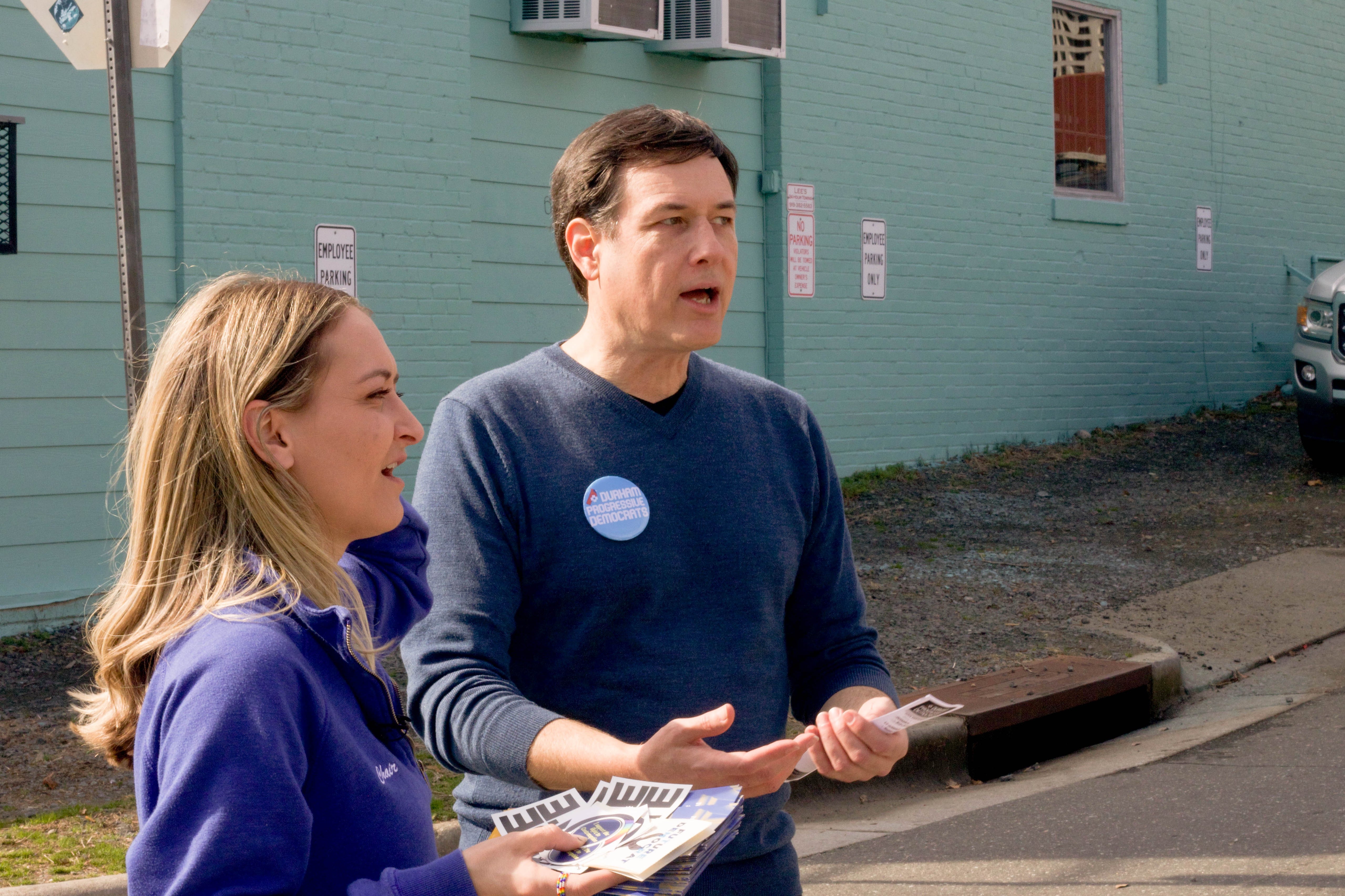 Anderson Clayton speaks with a Progressive Democrat leader in North Carolina while handing out flyers to potential voters