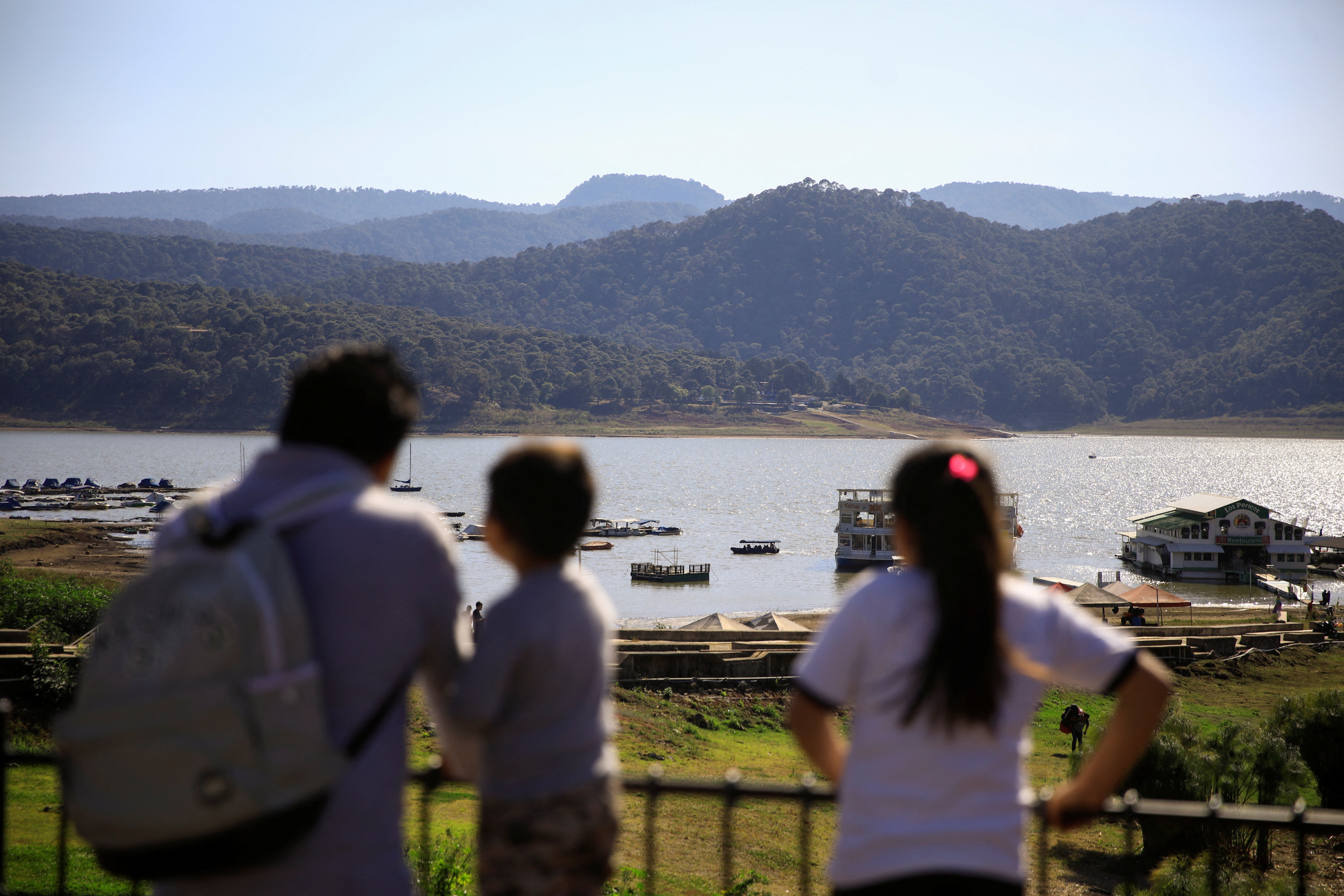 People look at the Valle de Bravo dam, in Valle de Bravo, Mexico February 21, 2024