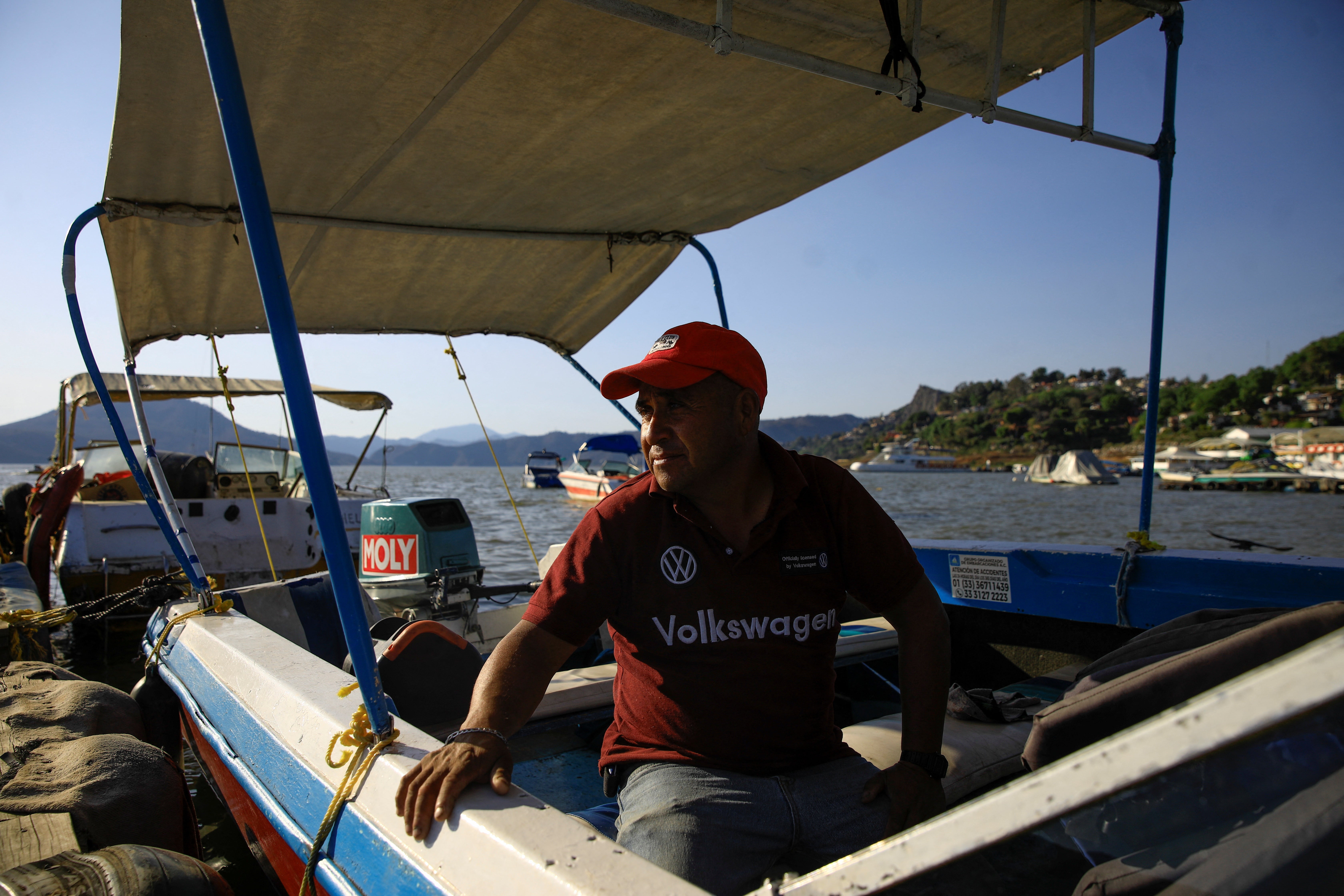 Mario Garcia, 48, sits on his boat the Valle de Bravo dam, in Valle de Bravo, Mexico February 21, 2024