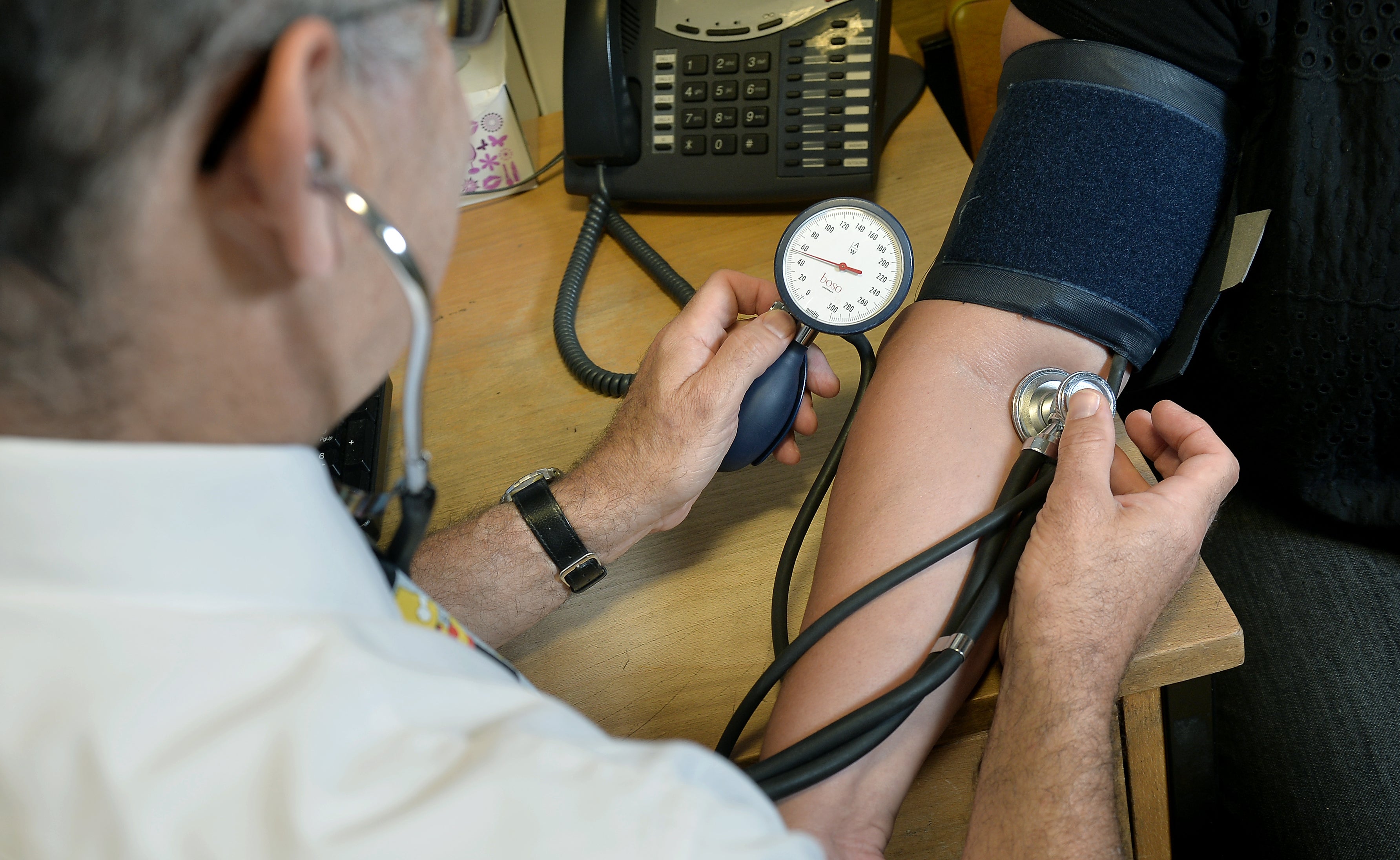 A GP taking a blood pressure reading