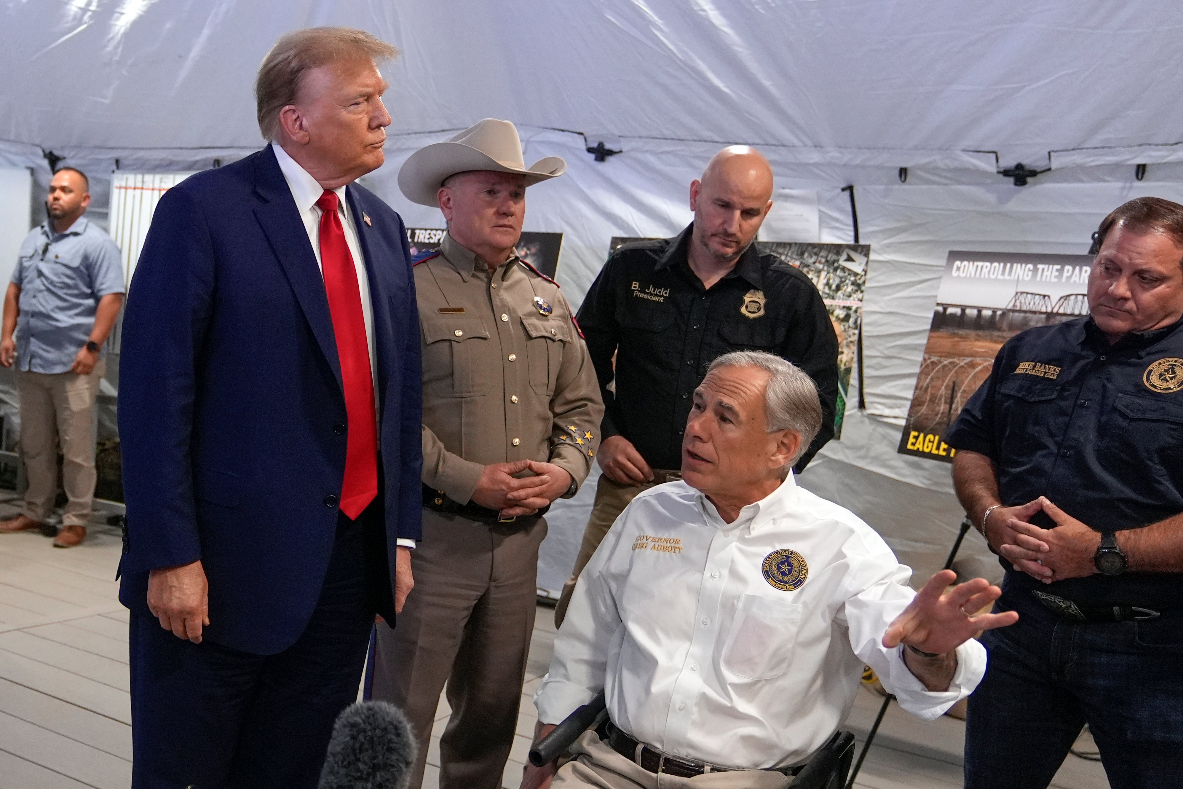 Mr Trump was met by Texas Governor Greg Abbott