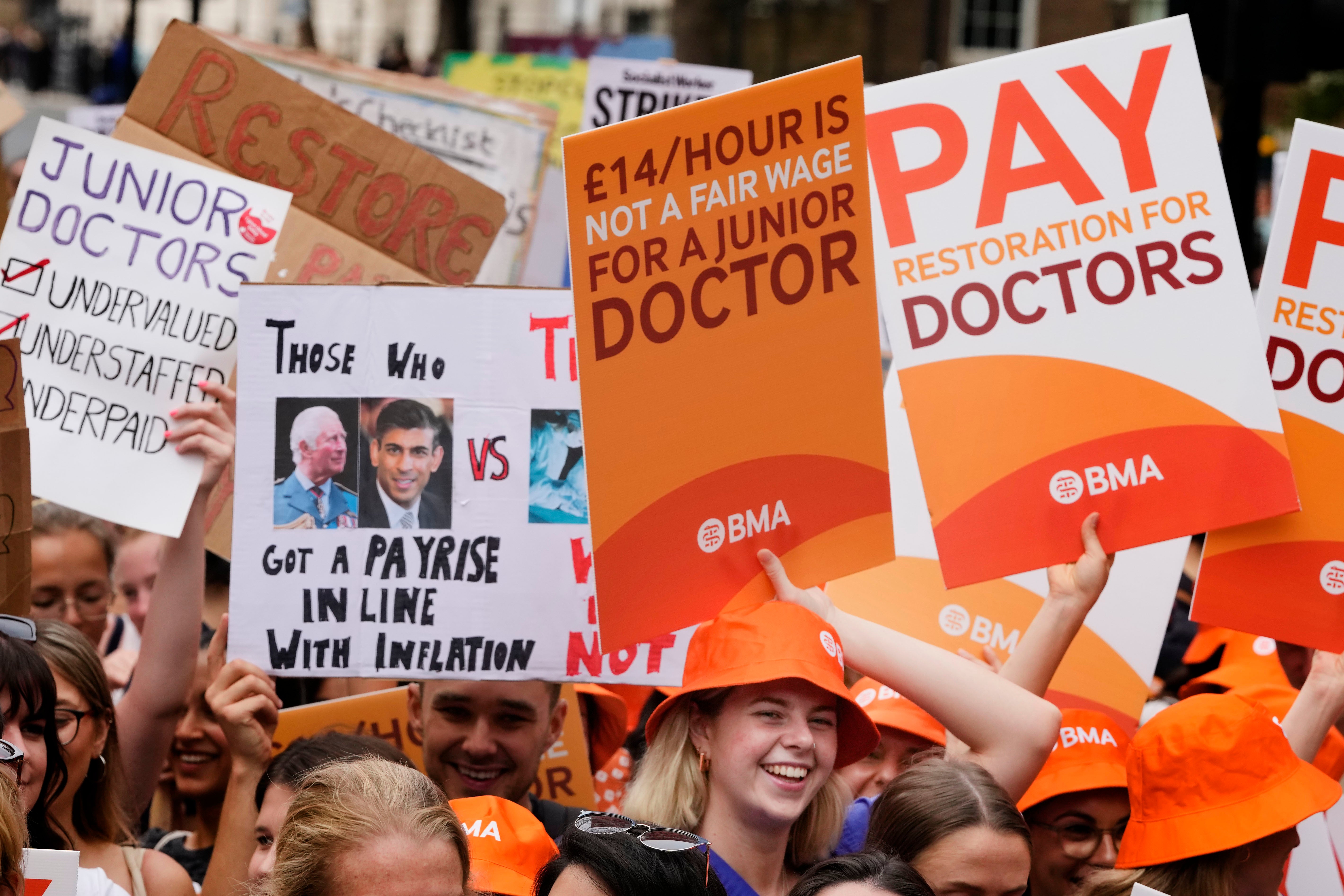 Demonstrators hold banners during a junior doctors rally outside Downing Street in London