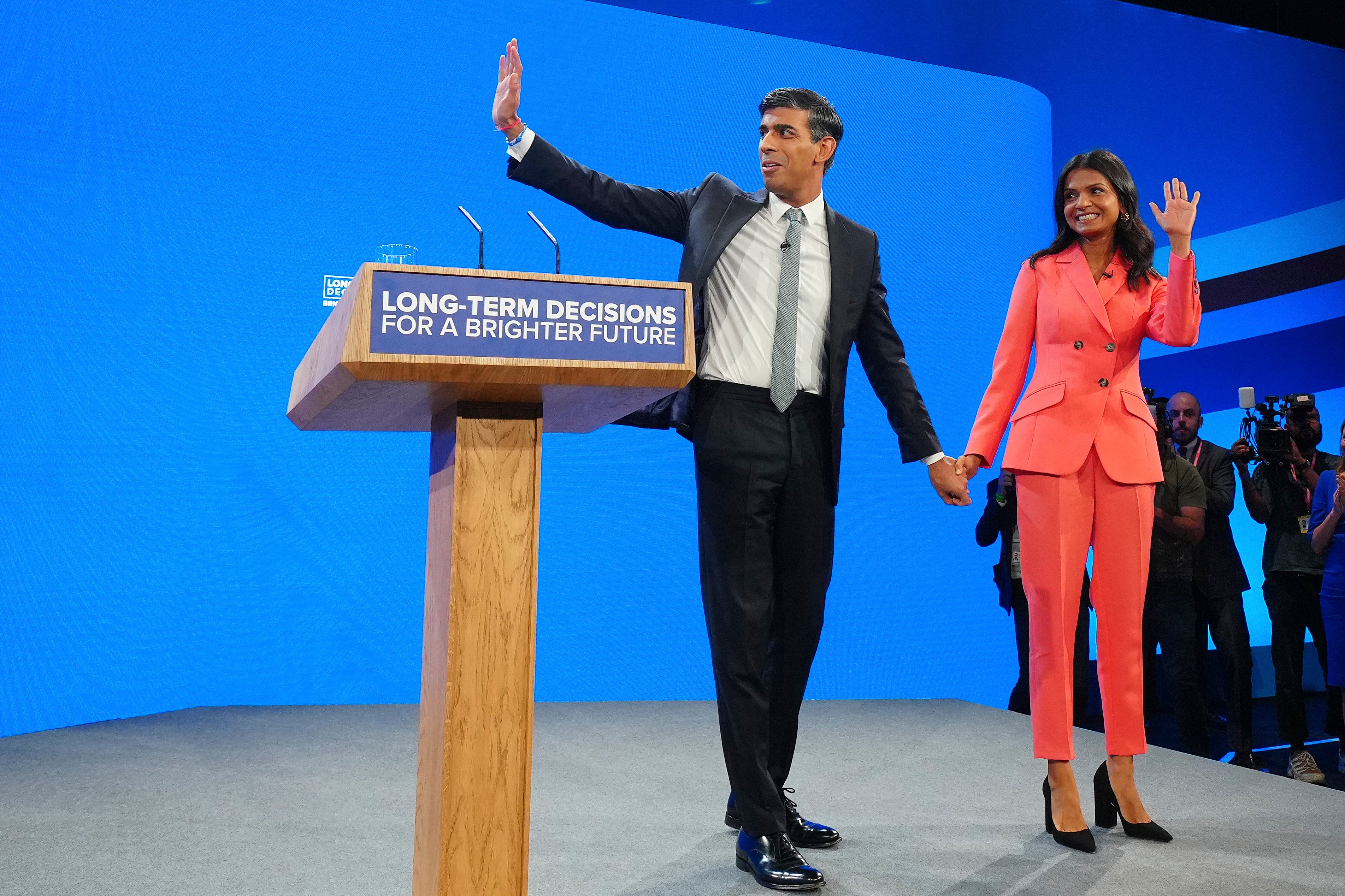 Rishi Sunak and wife Akshata Murty wave after his speech at the Conservative Party Conference