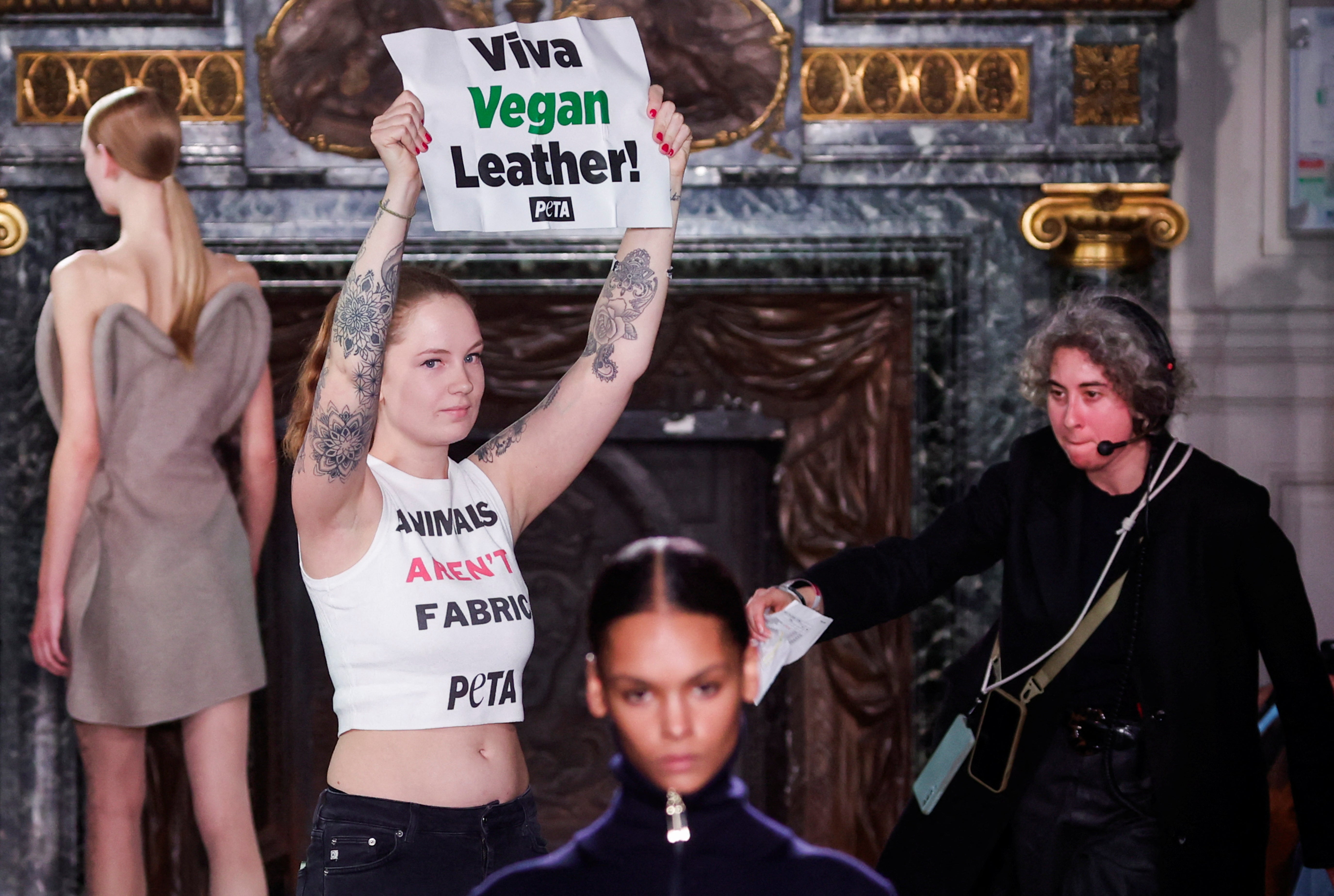 A PETA protester storms the runway