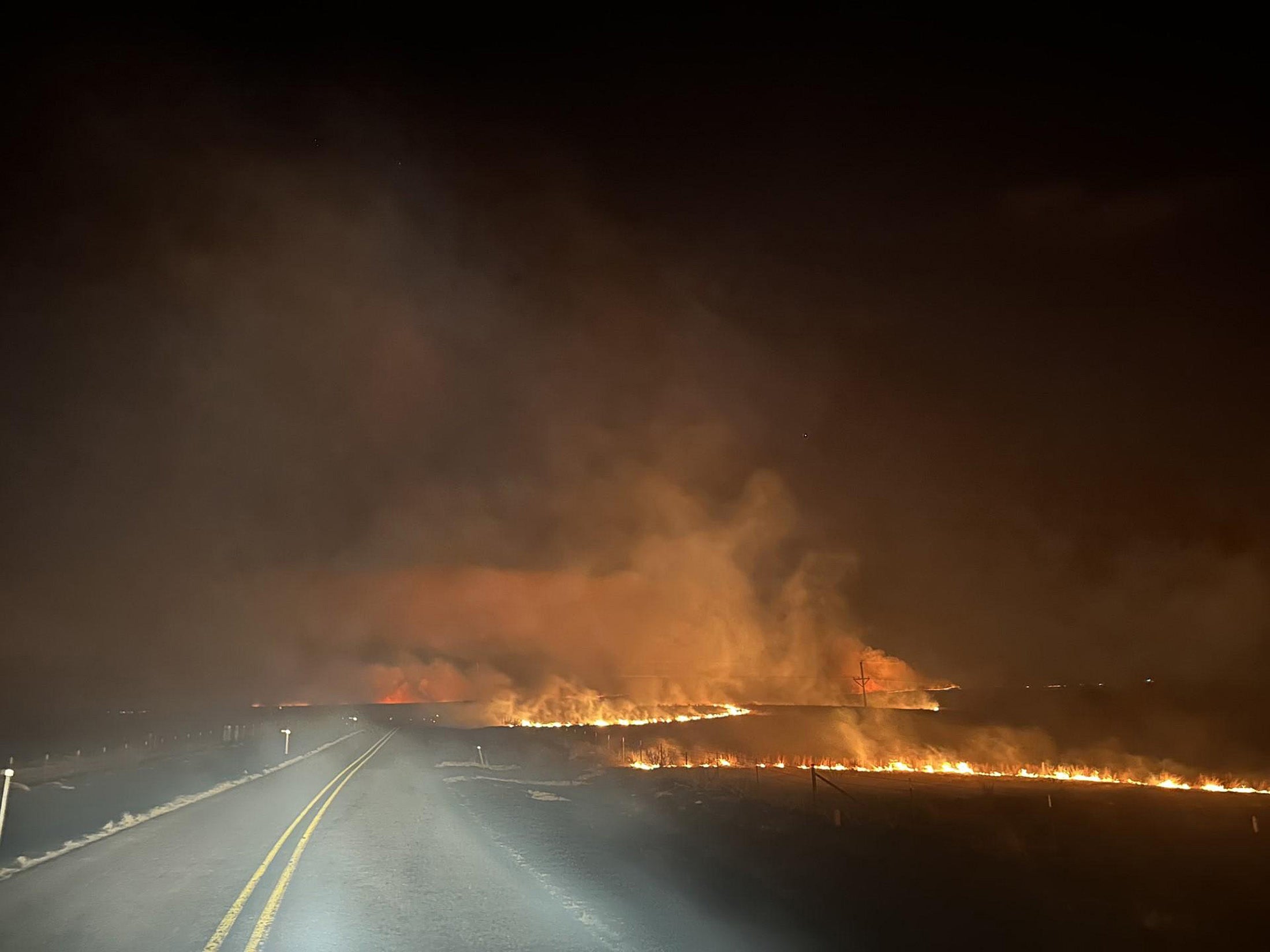 The Smokehouse Creek fire crosses a road on February 27, 2024 in the Texas Panhandle. Red flag warnings were in place on Monday in the south, raising concerns hot, dry conditions make kick up the blaze which has been brought under control