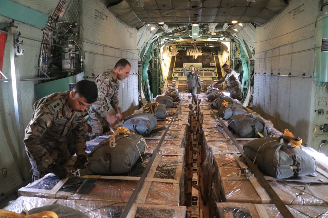 Members of the Jordanian armed forces prepare to drop aid parcels to several areas in northern Gaza