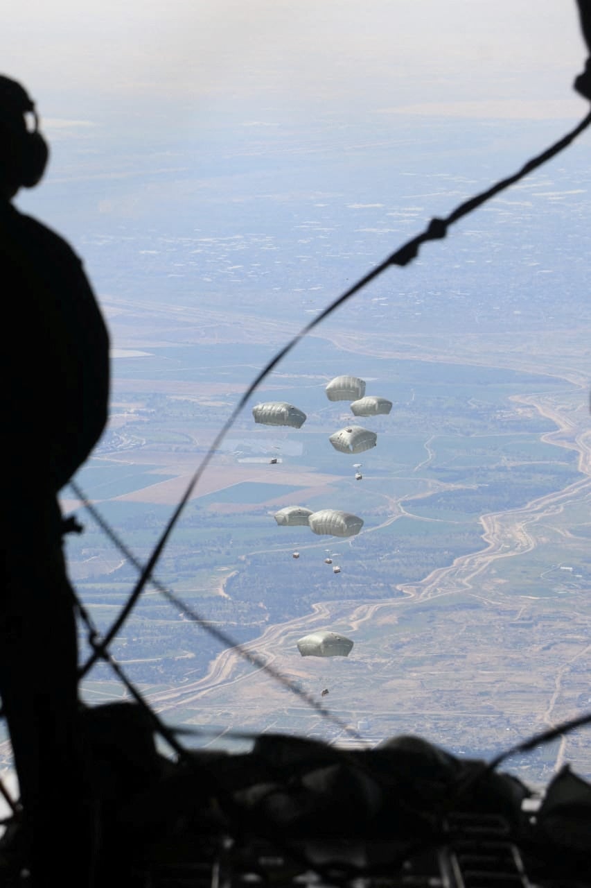 Jordanian armed forces members airdrop aid parcels to several areas in northern Gaza