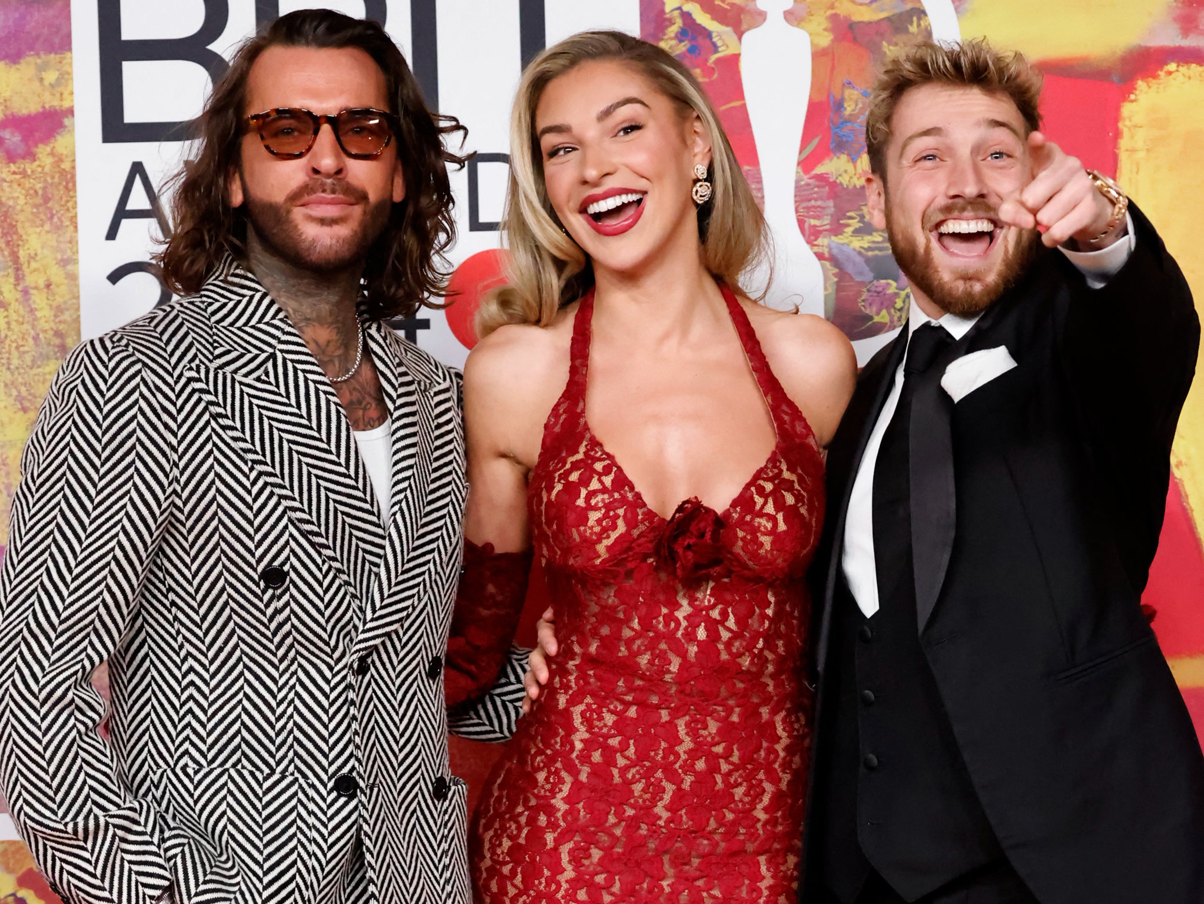 Left to right: Pete Wicks, Zara McDermott and Sam Thompson pose on the red carpet