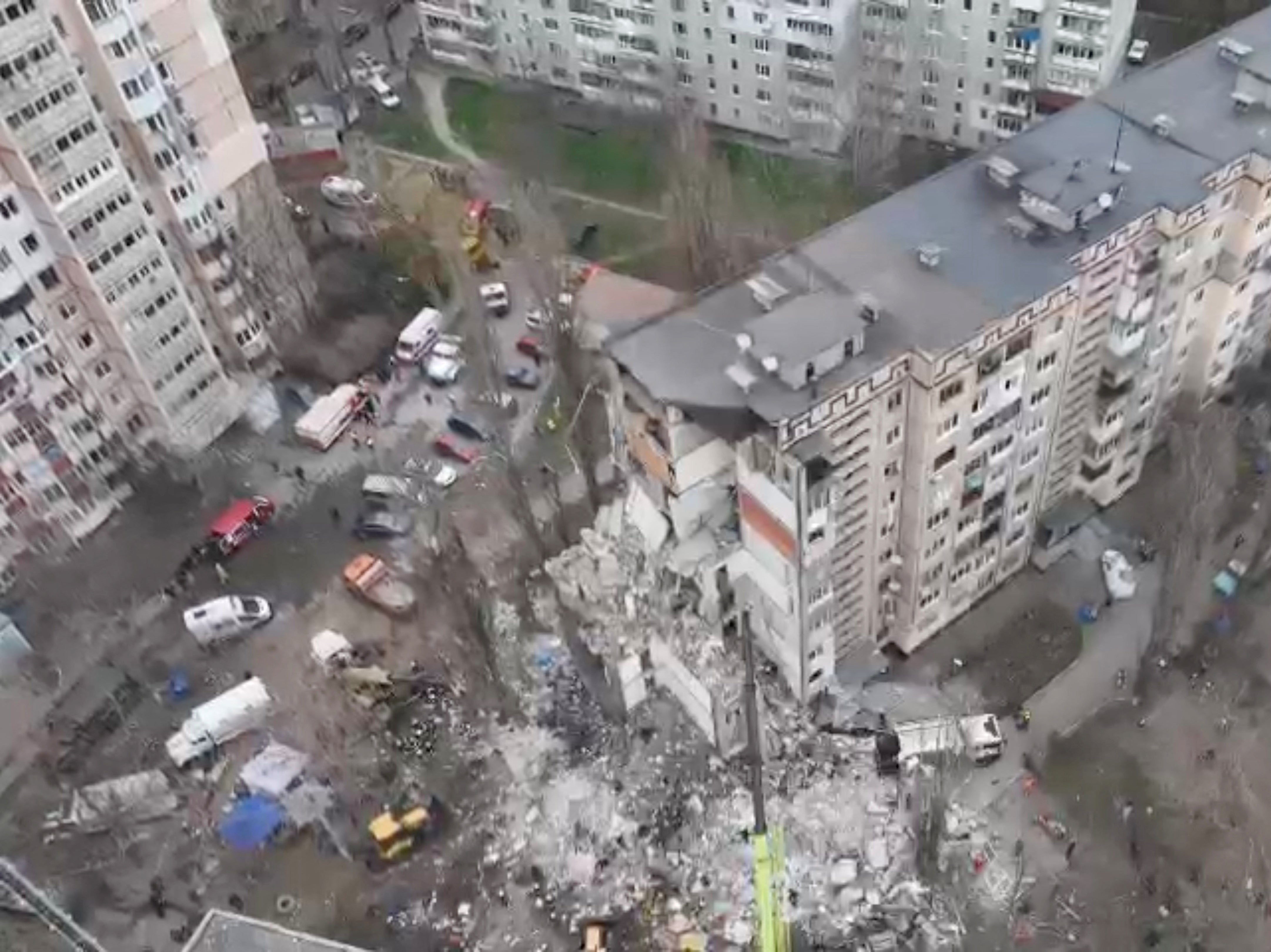 Drone view shows rescue crews working at the site of a residential building heavily damaged by a Russian drone strike that killed several residents in Odesa earlier this week