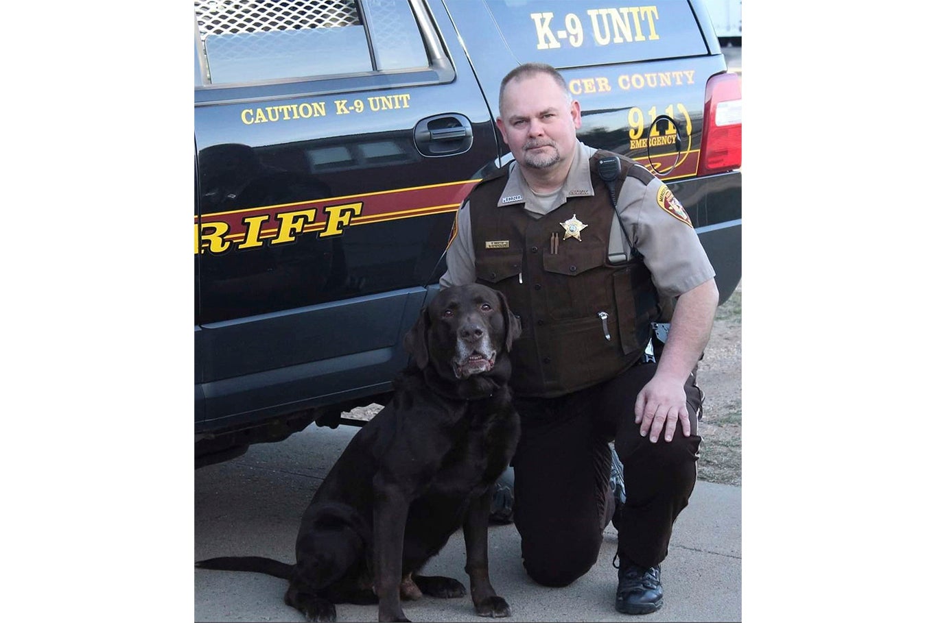 Martin kneeled beside his retired K9 Goliath in an undated photo