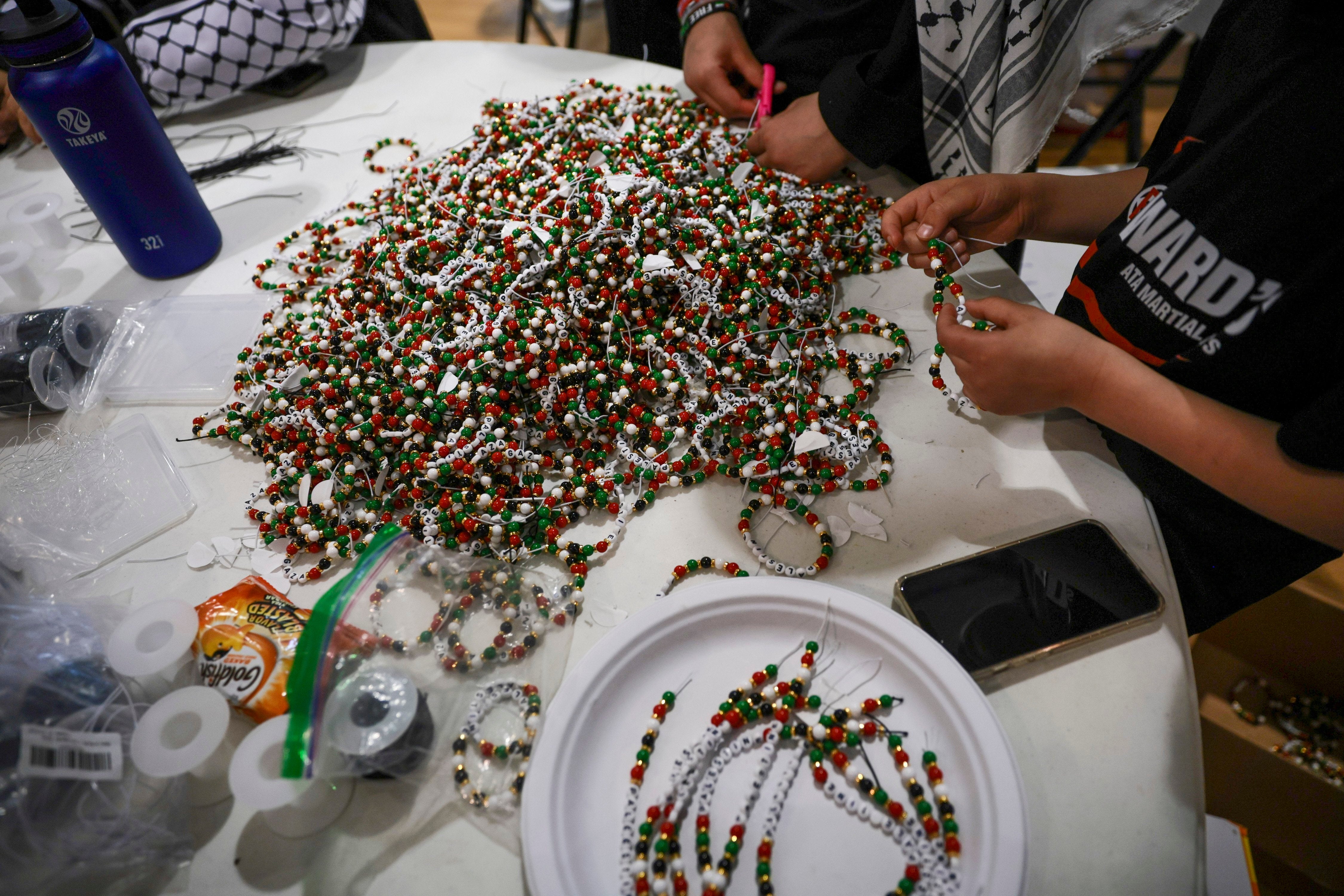 A heap of bracelets are almost finished, just needing to be tied together, for former Girl Scout Troop 149’s fundraiser