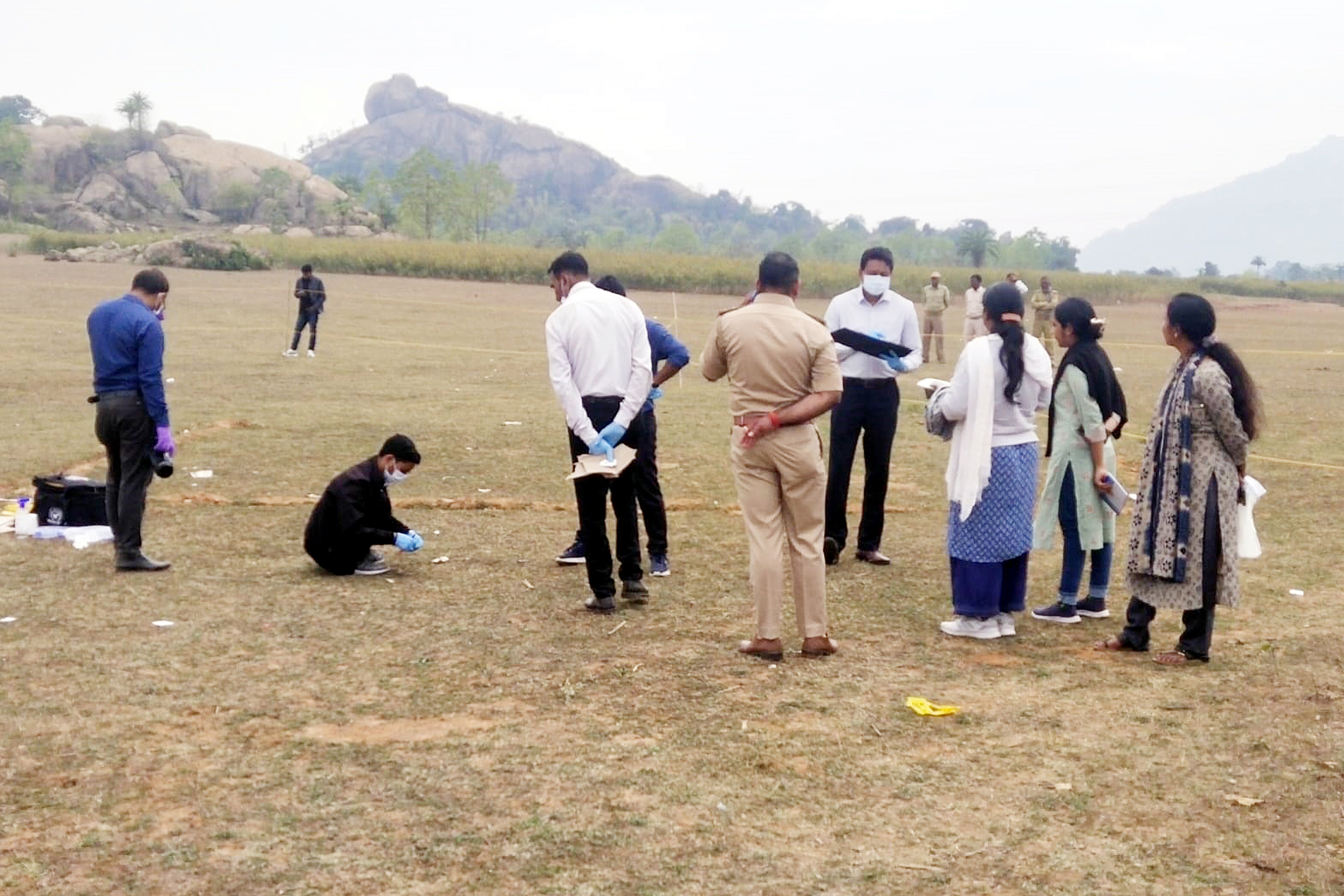 Indian police and forensic team investigate and collect samples at the site where a Spanish tourist was gangraped, near Kurmahaat, Dumka