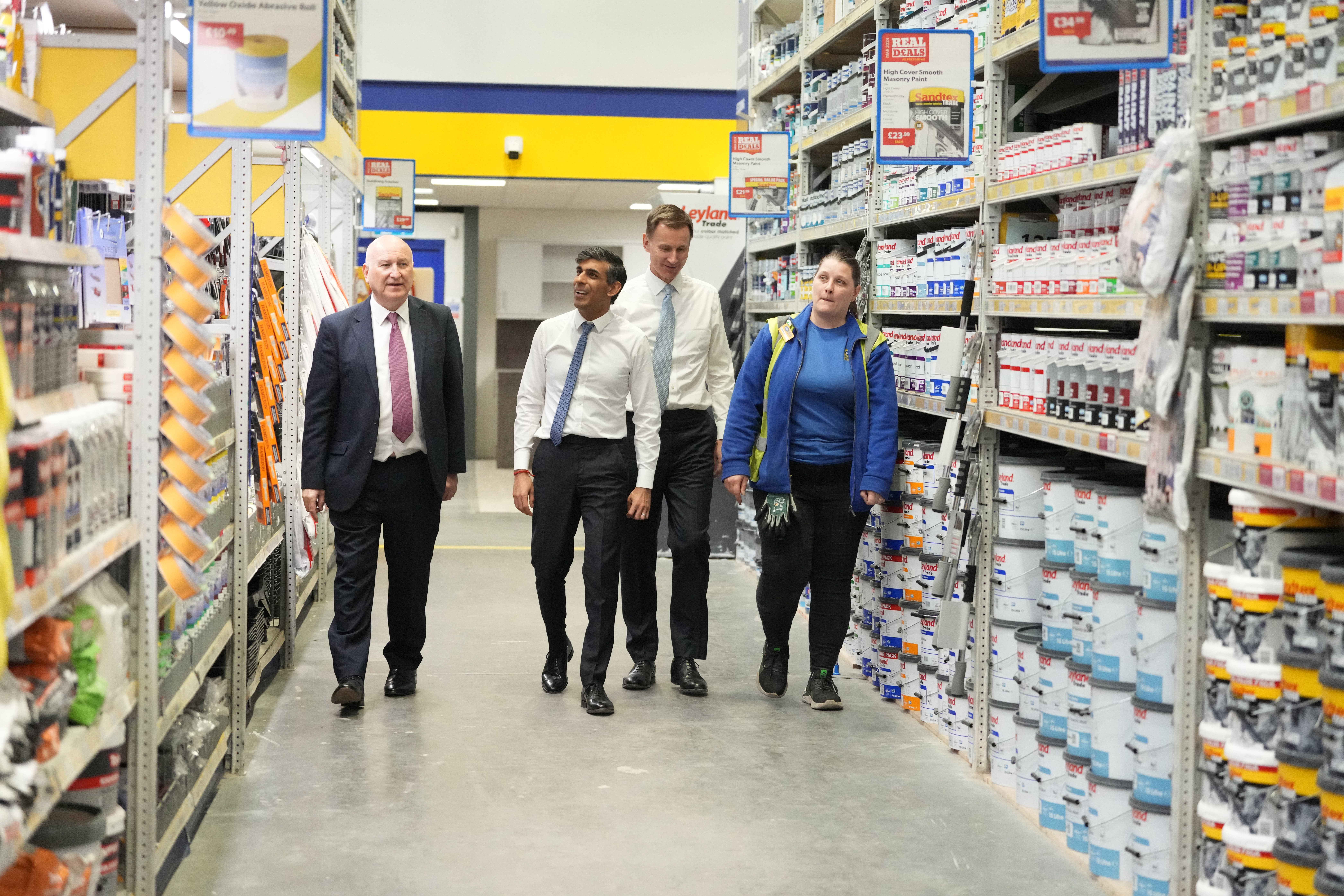 CEO of Selco Howard Luft, Prime Minister Rishi Sunak, Chancellor of the Exchequer Jeremy Hunt during a visit to a builders merchant in London (Kirsty Wigglesworth/PA)