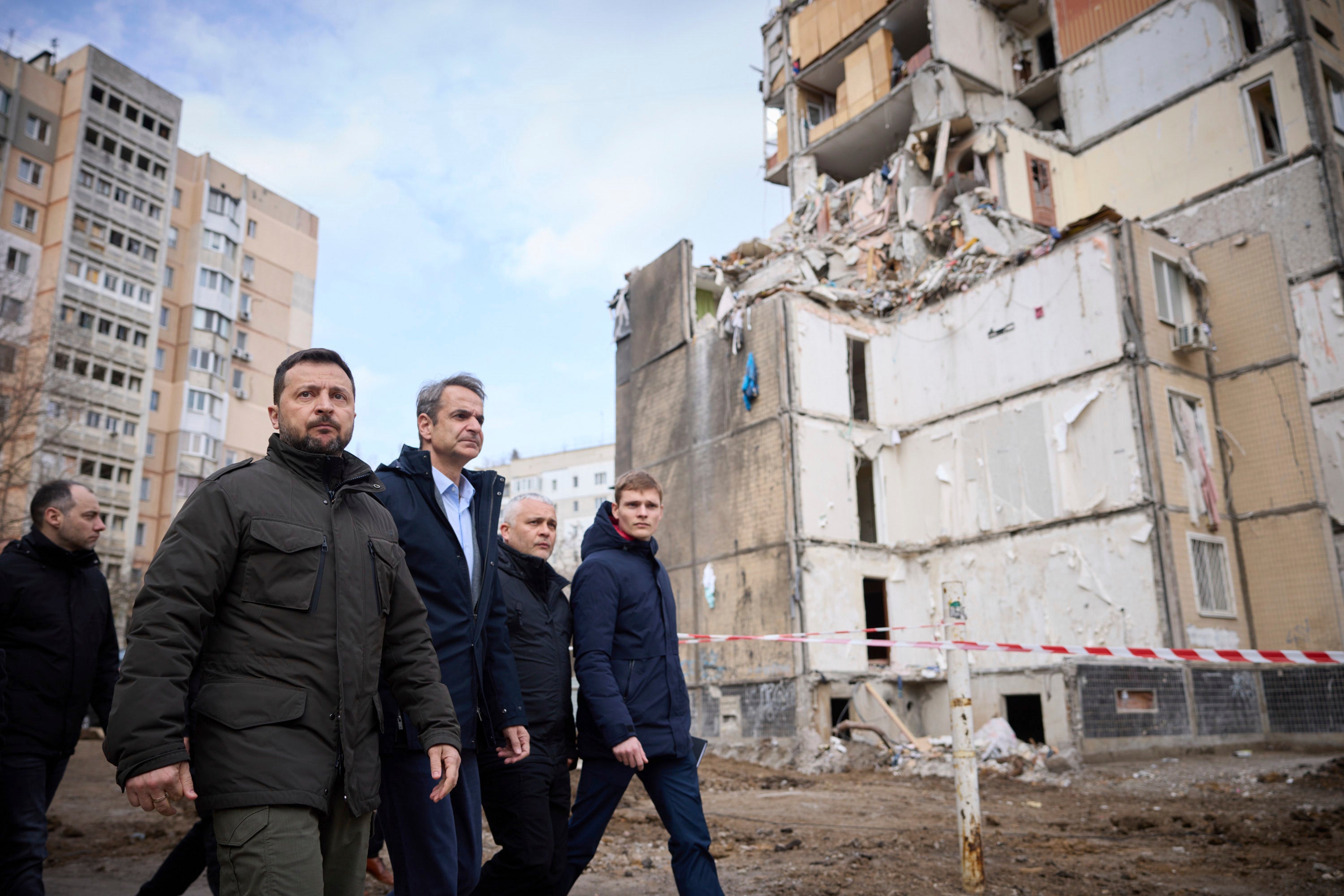 Ukrainian president Volodymyr Zelensky, second from left, and Greece’s prime minister Kyriakos Mitsotakis, third from left, walk in a residential area damaged by Russian attack in Odessa