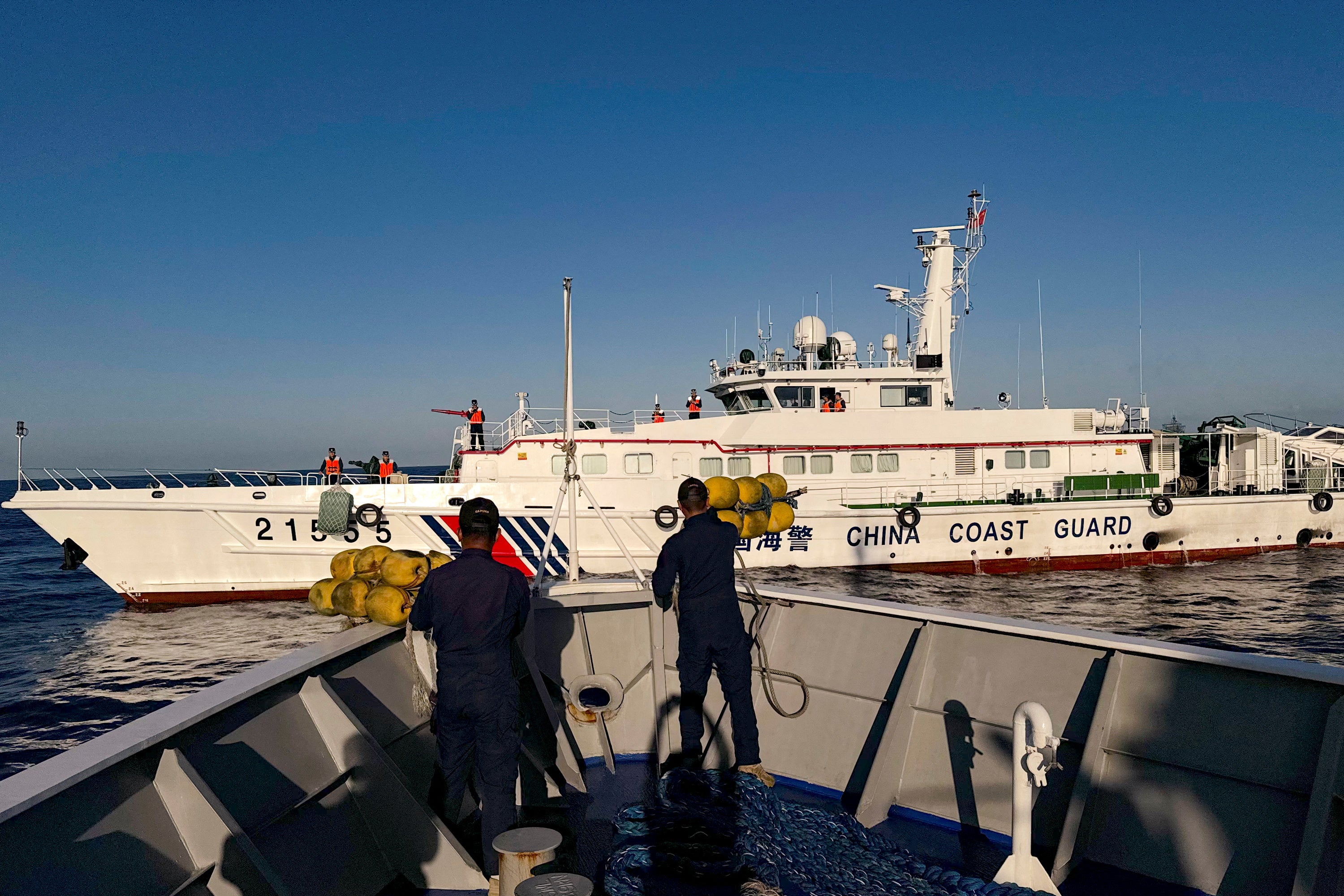 Philippine Coast Guard personnel prepare rubber fenders after Chinese Coast Guard vessels blocked their way to a resupply mission at the Second Thomas Shoal in the South China Sea, 5 March 2024