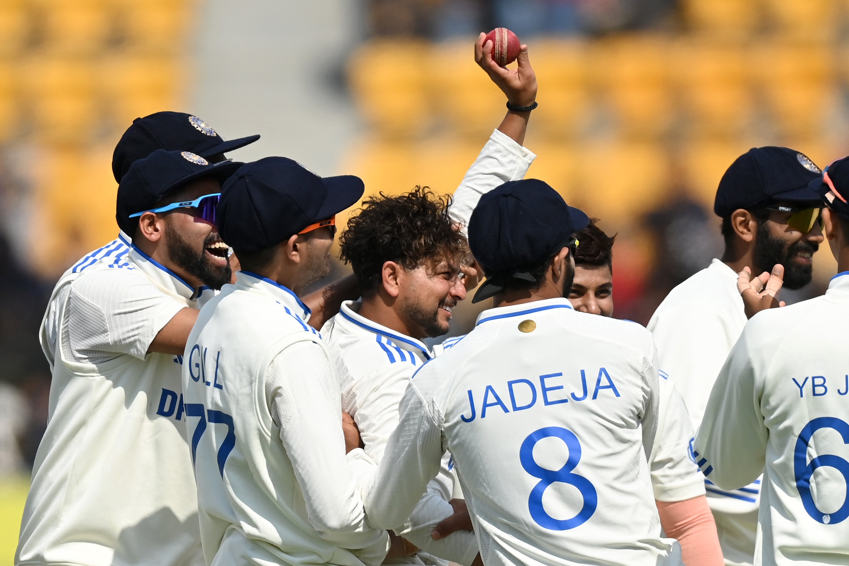 Kuldeep Yadav raises the ball in celebration after taking a five-wicket haul against England last year