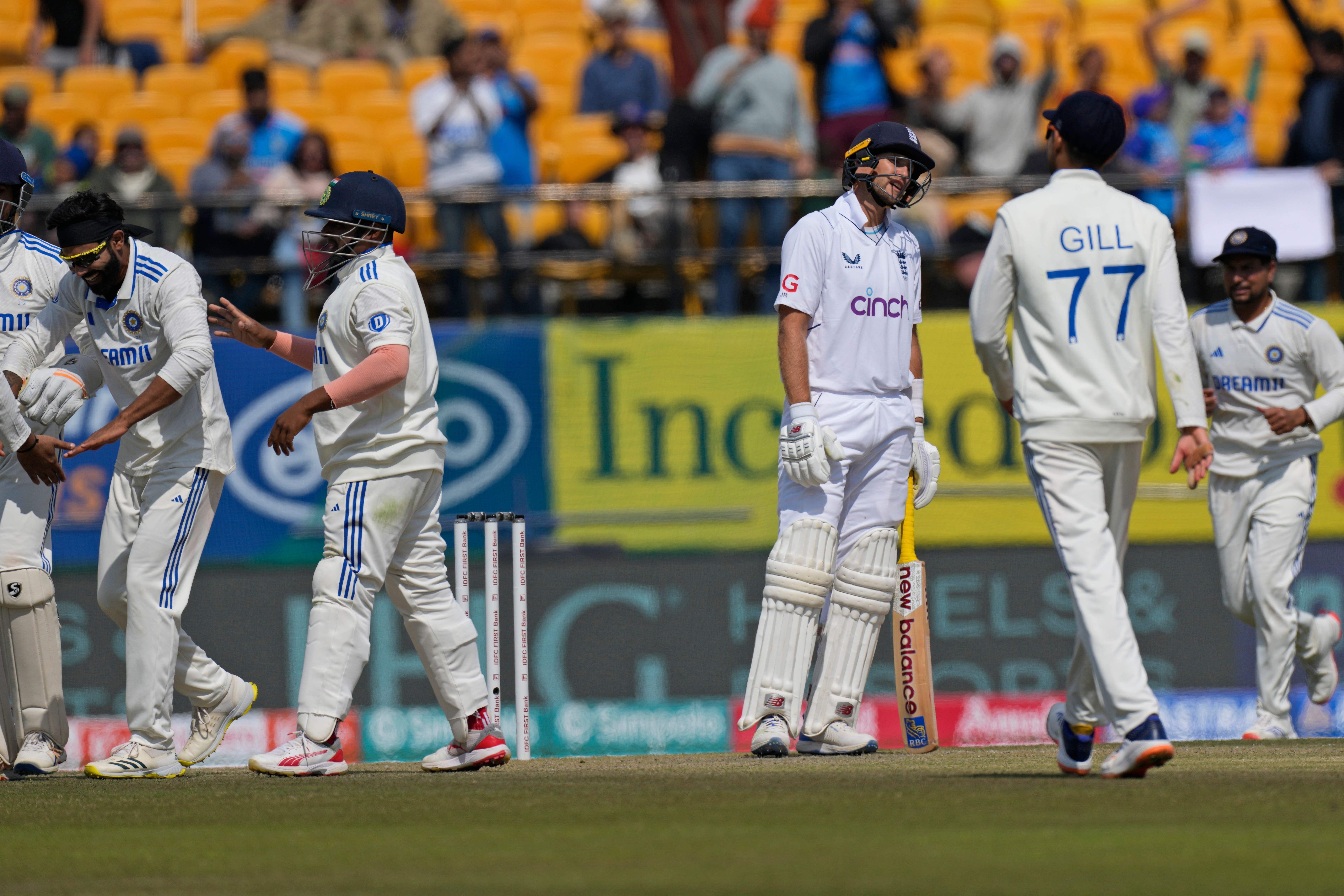 Joe Root, third right, reacts after being given out (Ashwini Bhatia/AP)