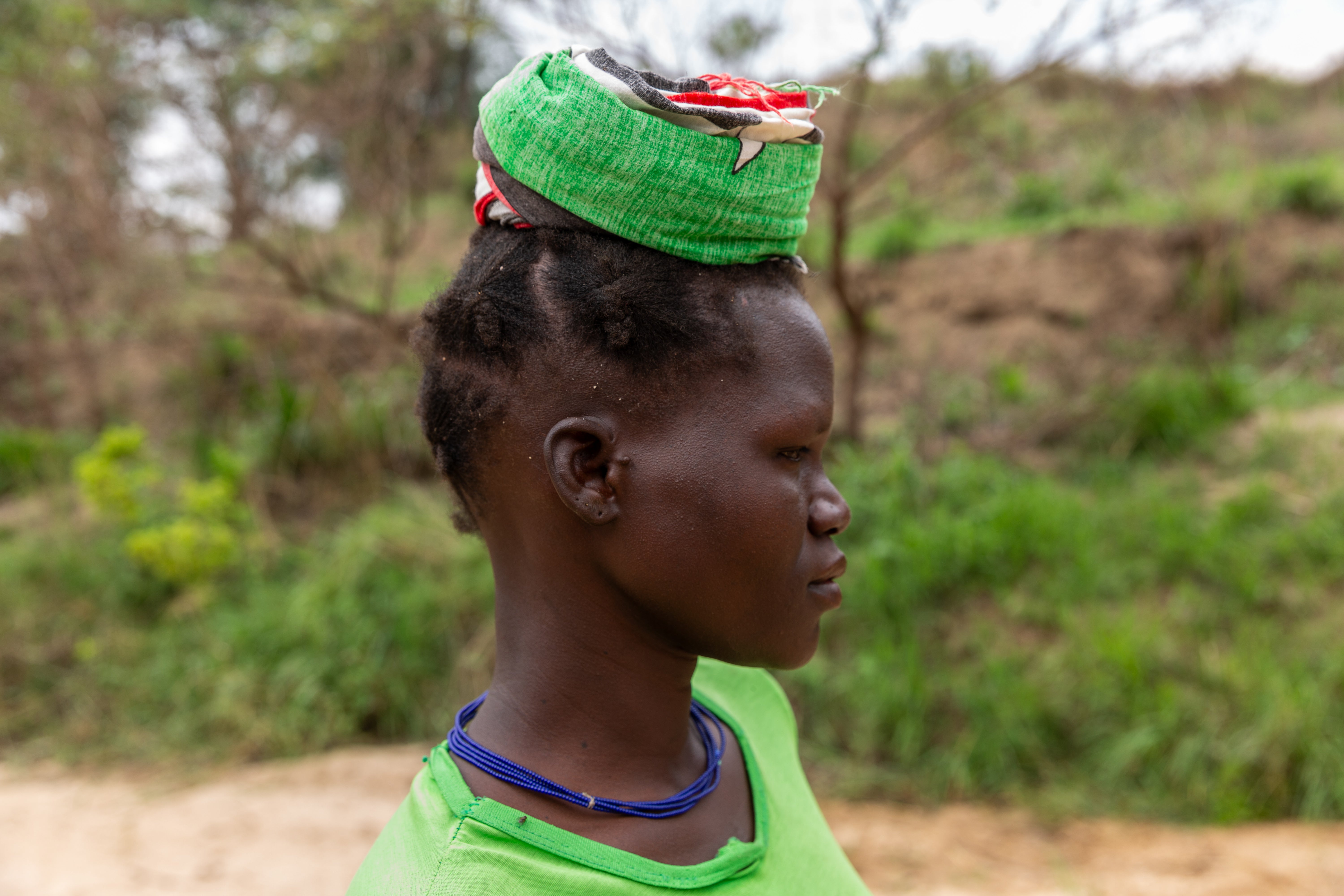 Lina Lokol, 30, getting ready to carry a 20 litre jerrycan full of water back home from River Nataa, Ariamaoi village, Nabiratuk District, Karamoja region, Uganda