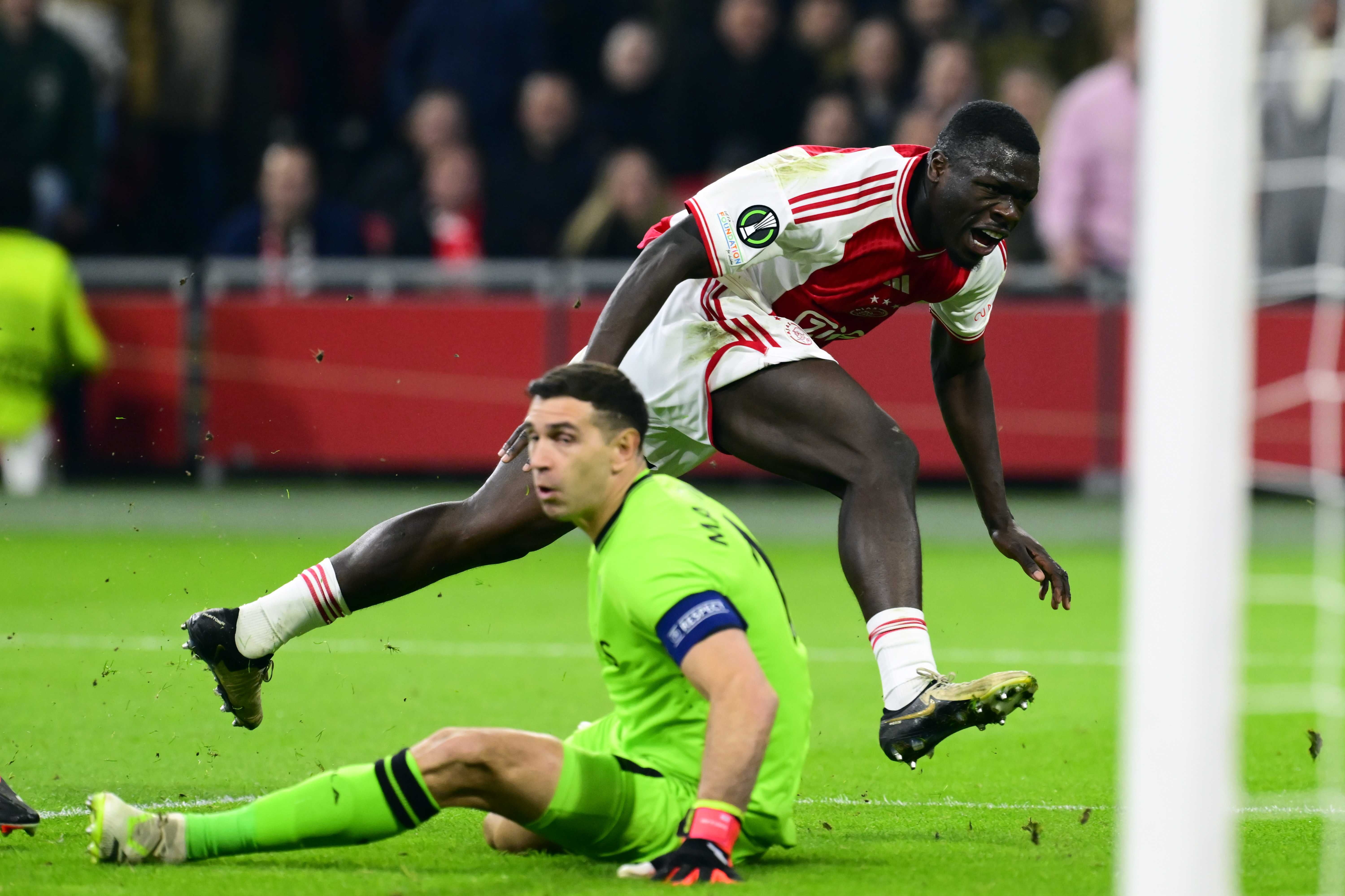 Aston Villa goalkeeper Emiliano Martinez (front) and Brian Brobbey of Ajax in action