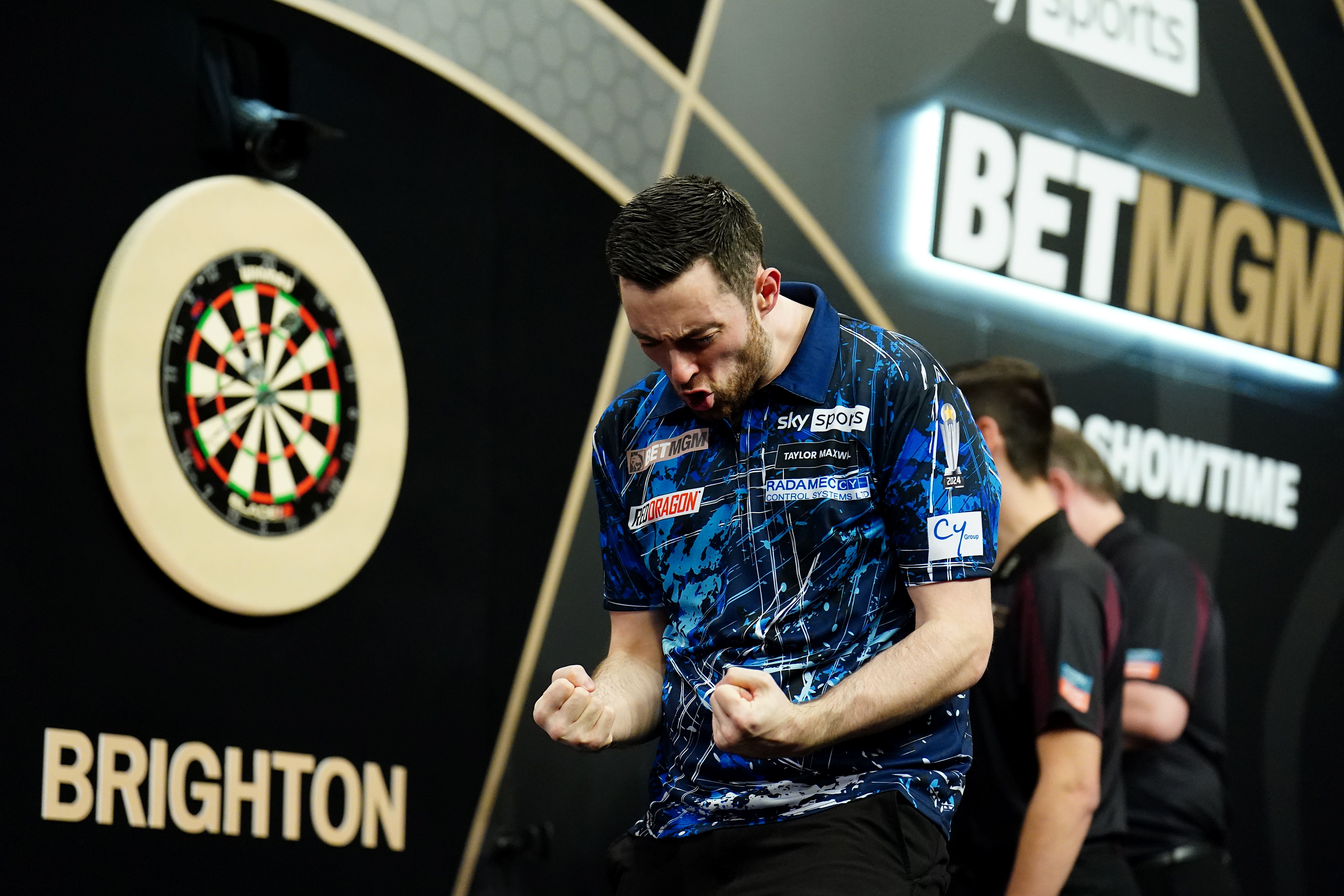 Luke Humphries celebrates after beating Michael Smith in Brighton (Zac Goodwin/PA)